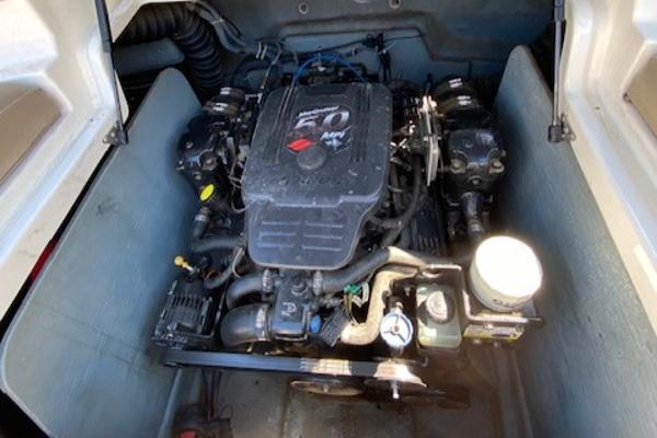 Engine compartment of a 2005 Bayliner 249 SD boat, featuring a 5.0 MPI engine.