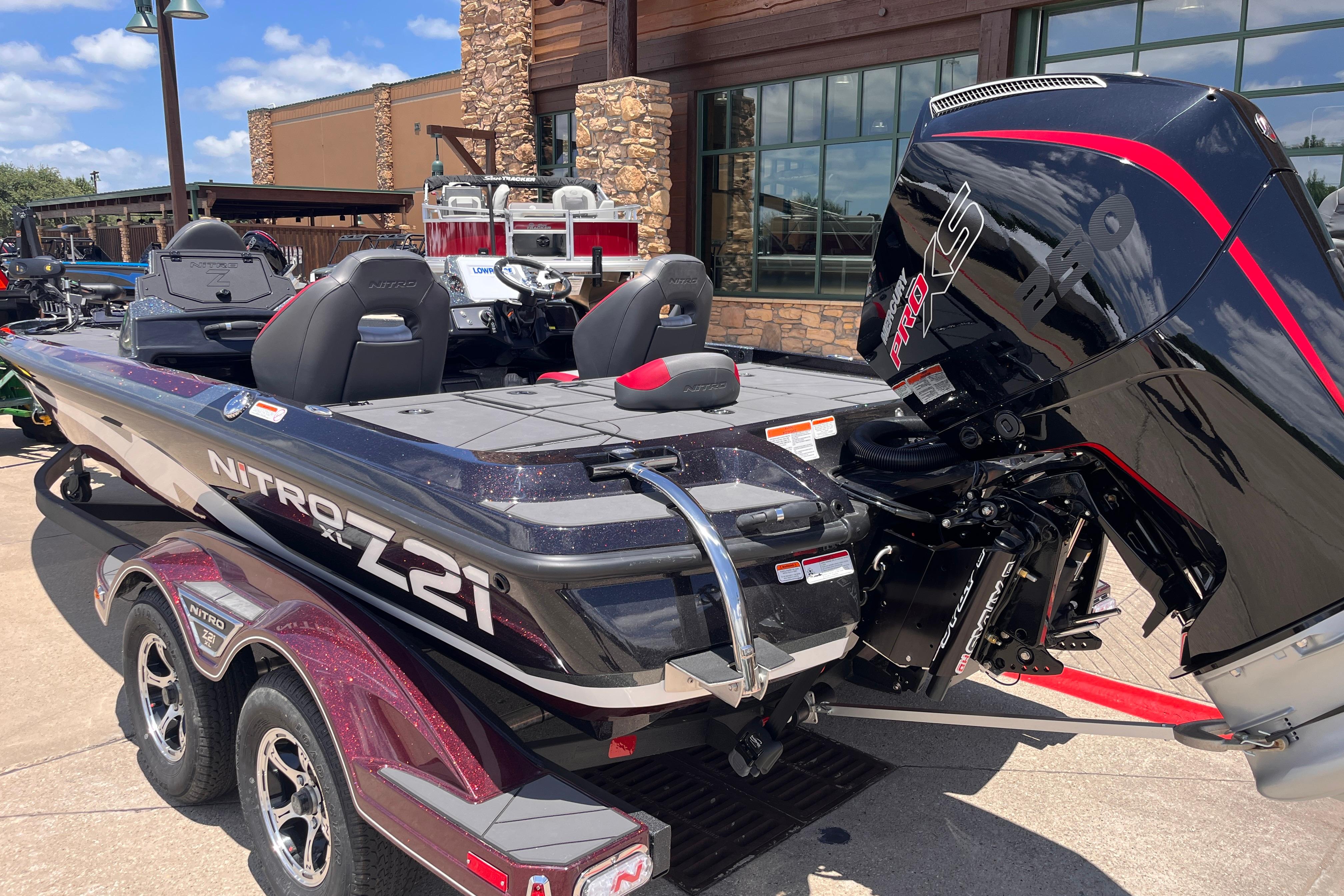 2026 Nitro Z21 XL boat with powerful engine, parked outdoors on a sunny day.