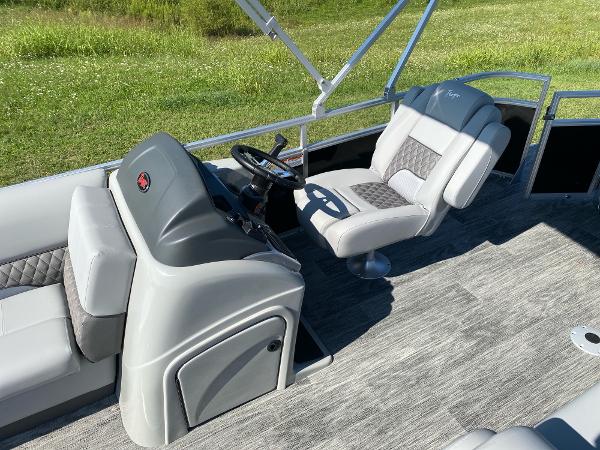 2024 Ranger Reata 223C boat interior with gray seating and steering console.