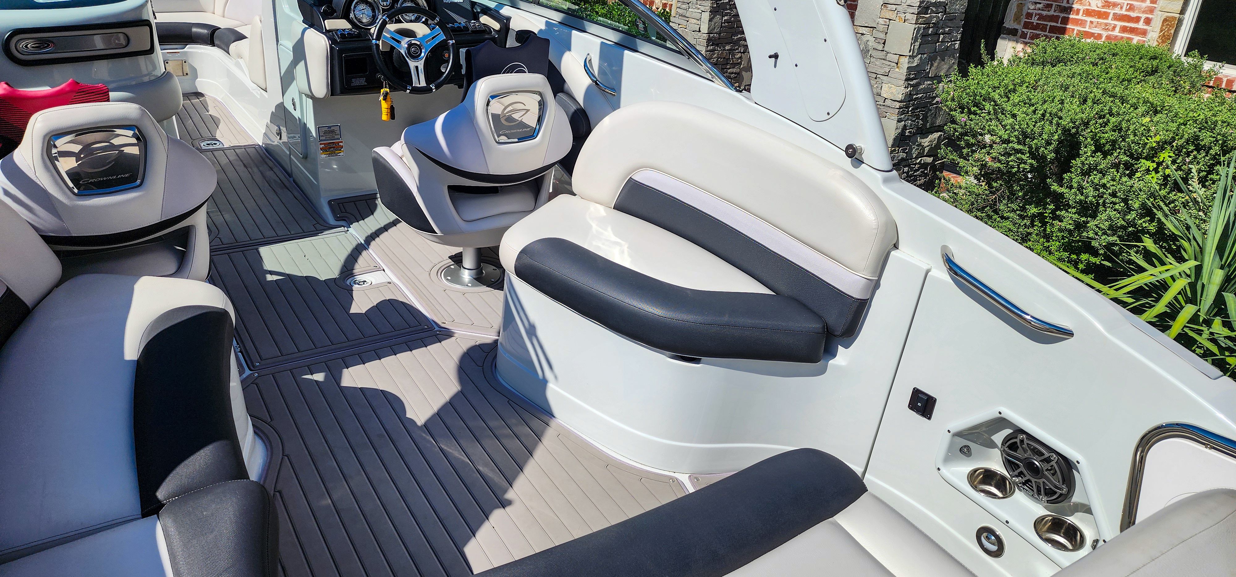 The image shows the cockpit of a 2017 Crownline 285SS boat with sleek seating and modern features.