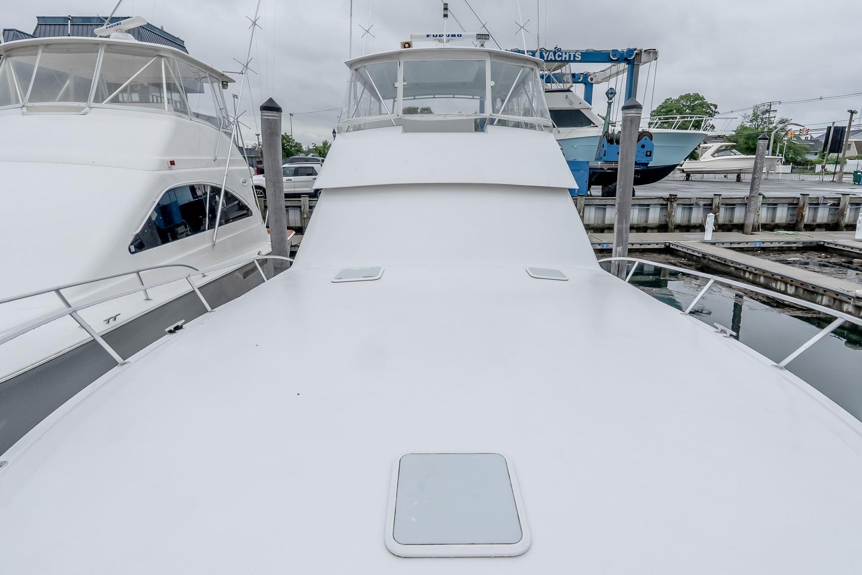 2000 Viking 50' Convertible yacht docked at marina, showcasing sleek design and spacious deck.
