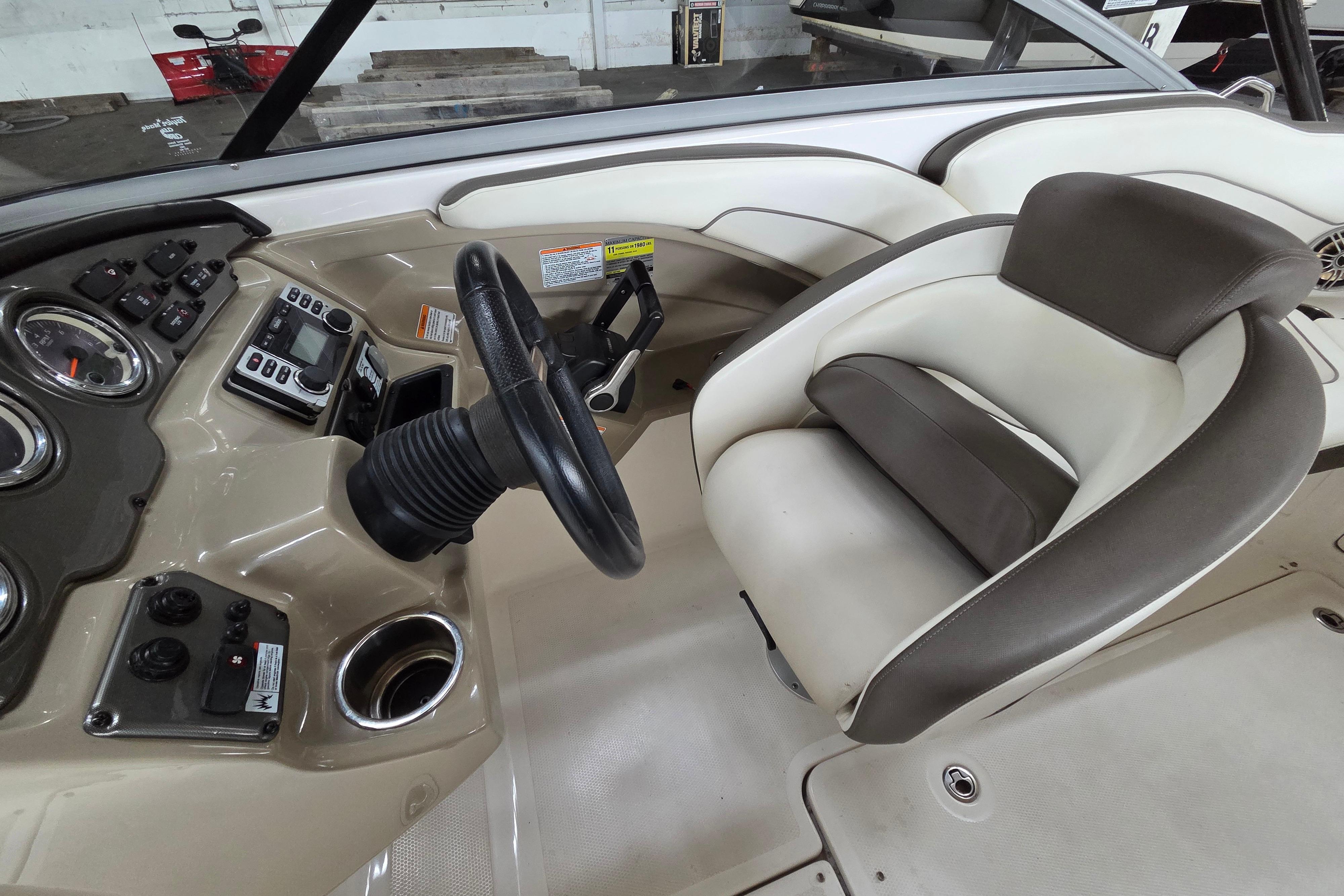 2013 Yamaha 242 Limited S boat interior with steering wheel and control panel.