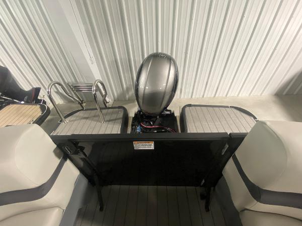 2024 Starcraft EXS 1 boat interior with motor and seating.