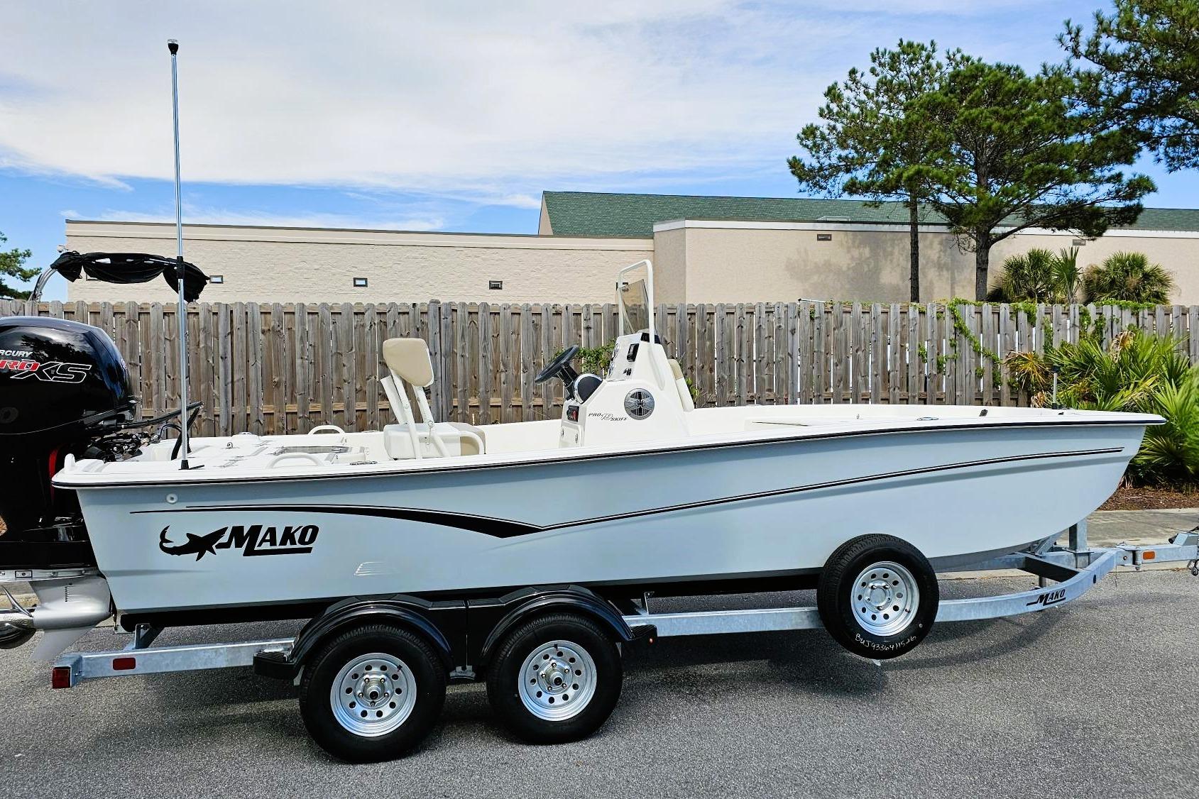 2026 Mako Pro Skiff 19 CC boat on trailer, parked outdoors.