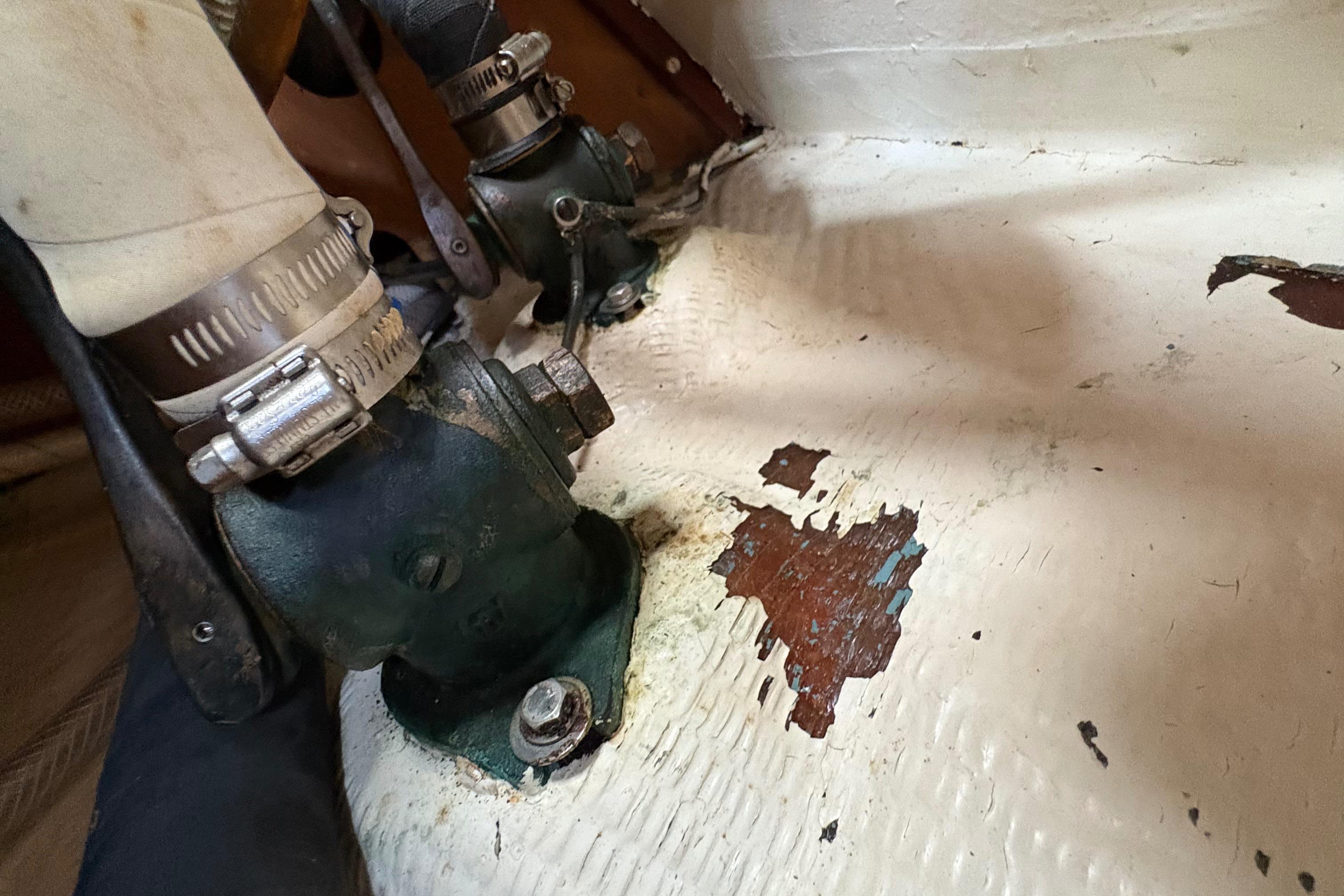 Aging plumbing components on a 1981 Sabre 31 boat with peeling paint.