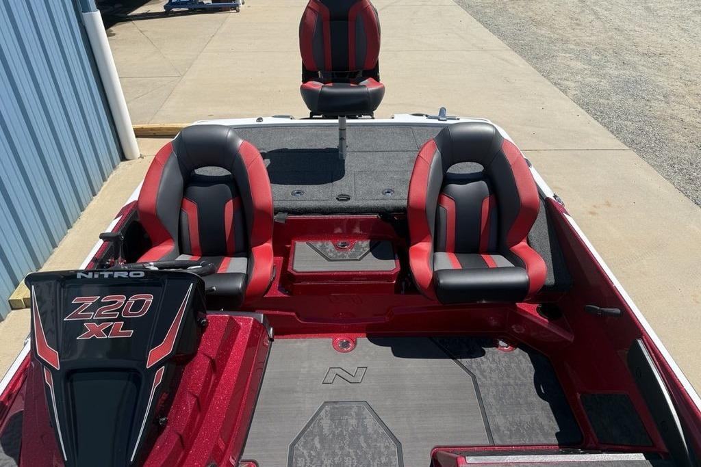 2026 Nitro Z20 XL Pro boat interior with red and black seating, docked outdoors.