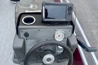 2026 Sun Tracker Bass Buggy 18 DLX dashboard with steering wheel and navigation system.