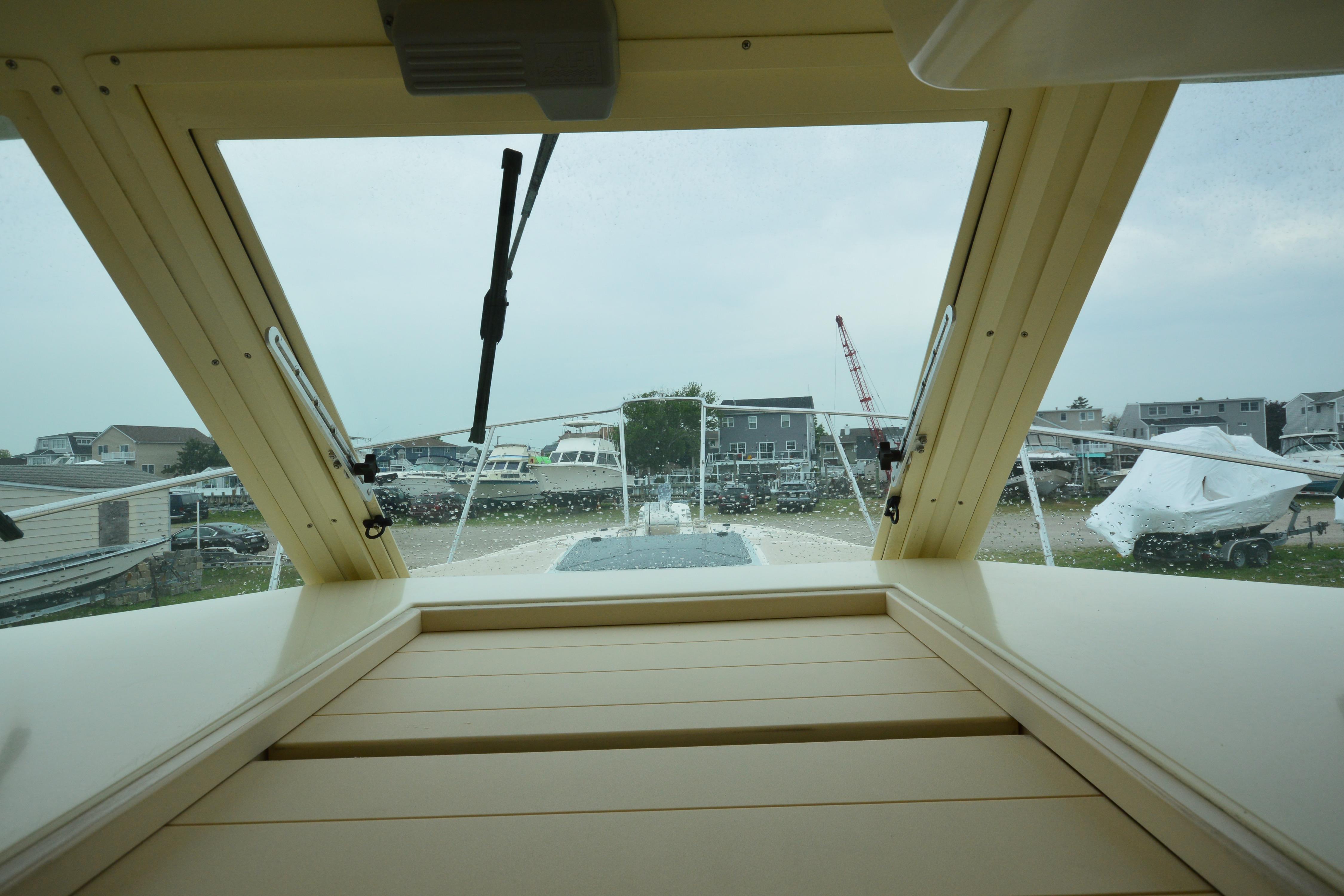 Interior view from a 2001 Albin 28 Tournament Express boat, showcasing the windshield and marina.