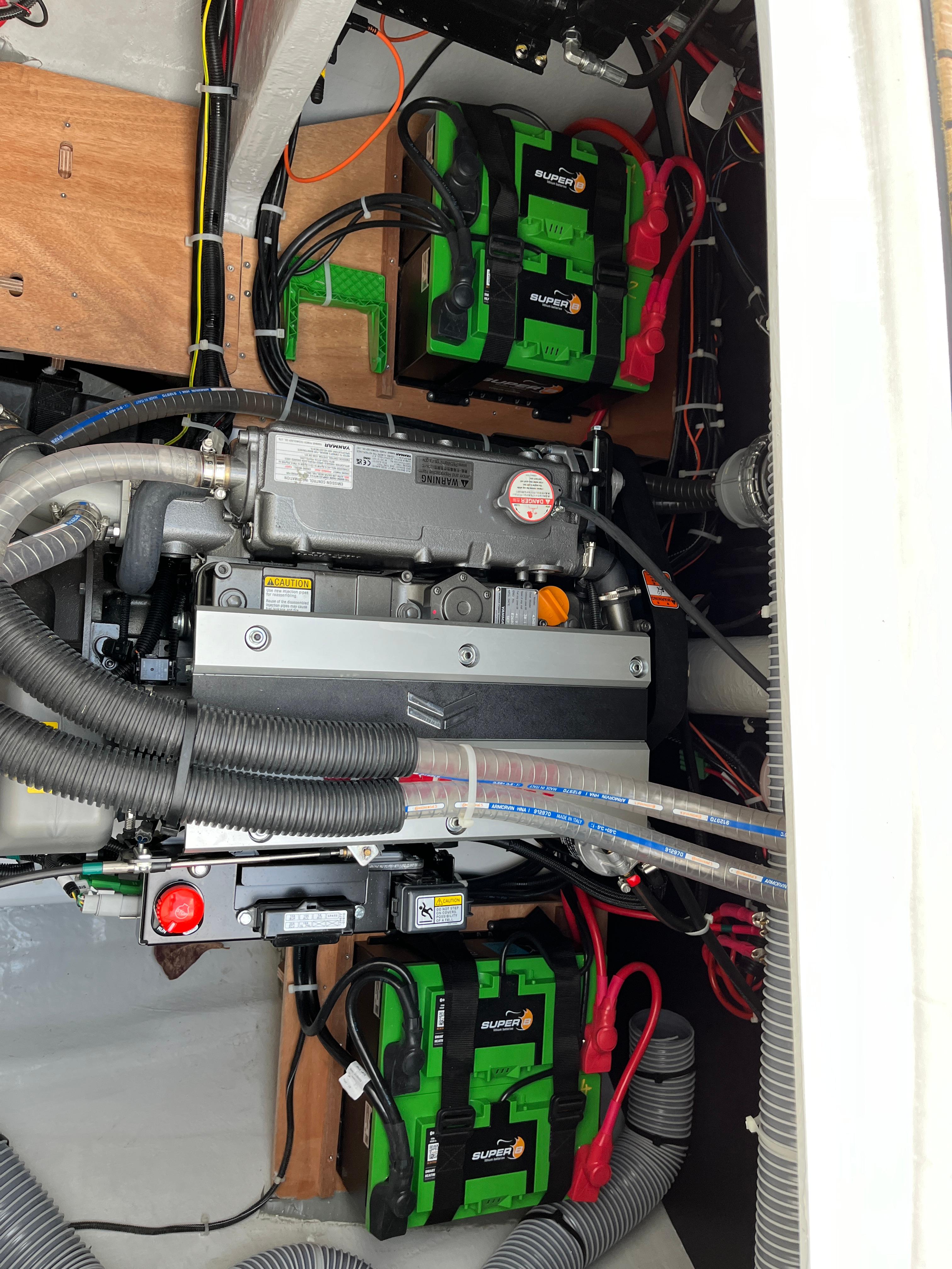 Engine compartment of a 2024 Lagoon 46 catamaran with batteries and wiring.