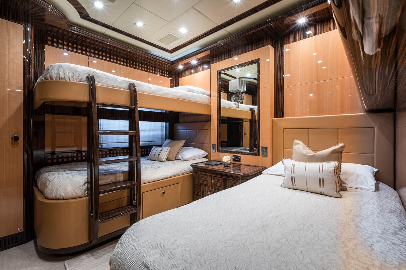 Luxurious 2011 Mangusta 165 yacht bedroom with bunk beds and elegant decor.