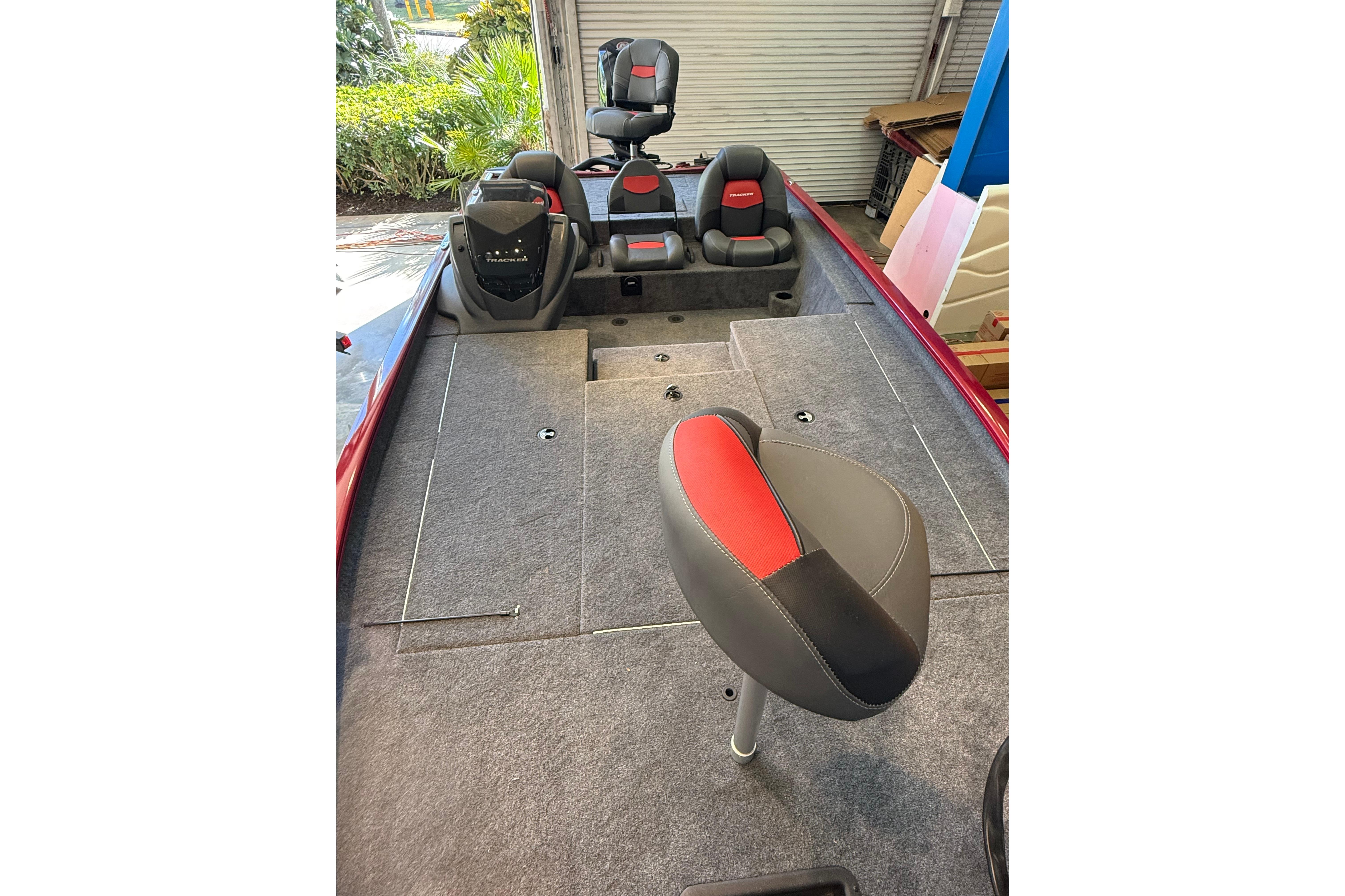 2025 Tracker Savage 215 boat interior with red and gray seating, showcasing spacious design.