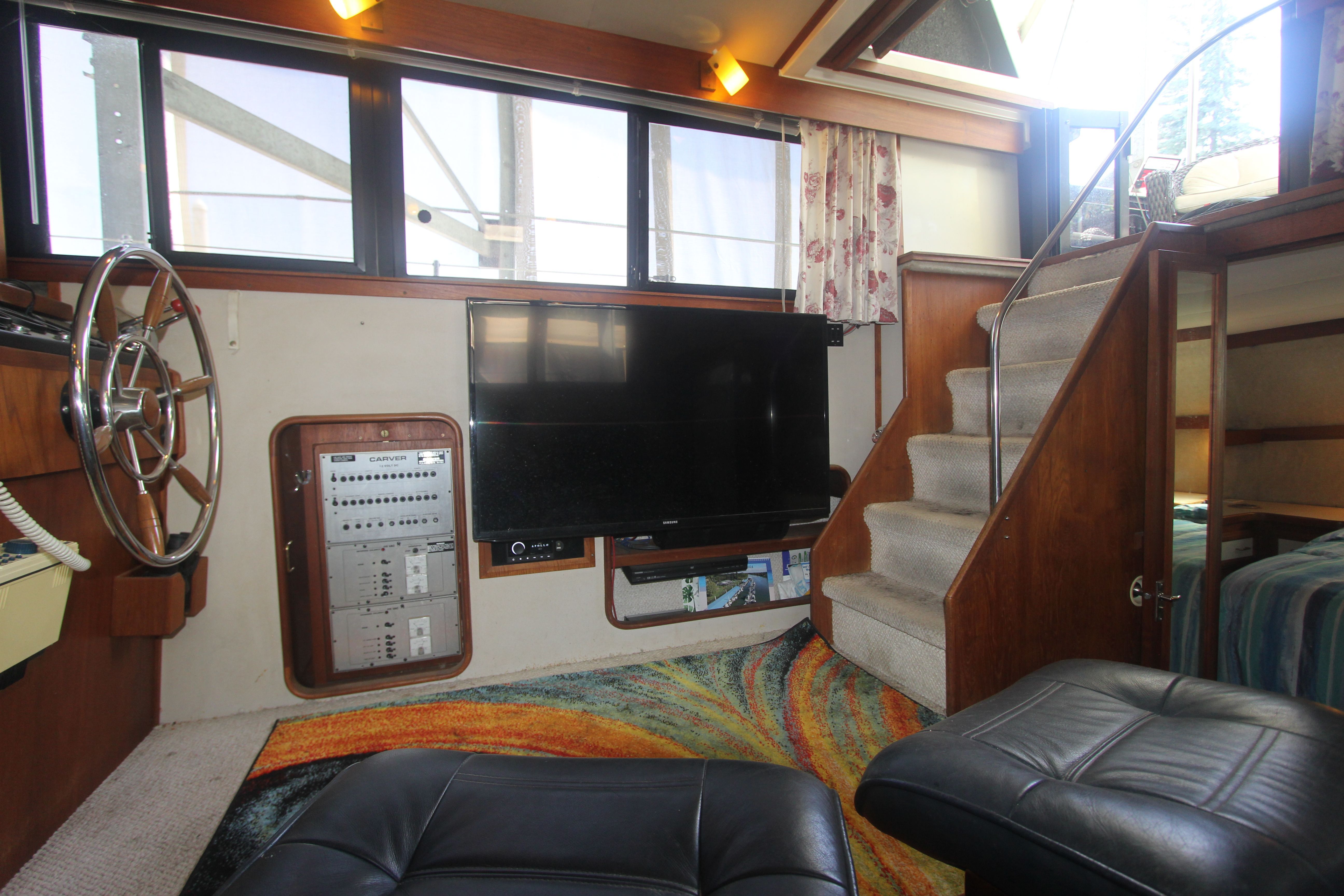 Interior of the 1988 Carver 3607 Aft Cabin Motor Yacht with helm and staircase.
