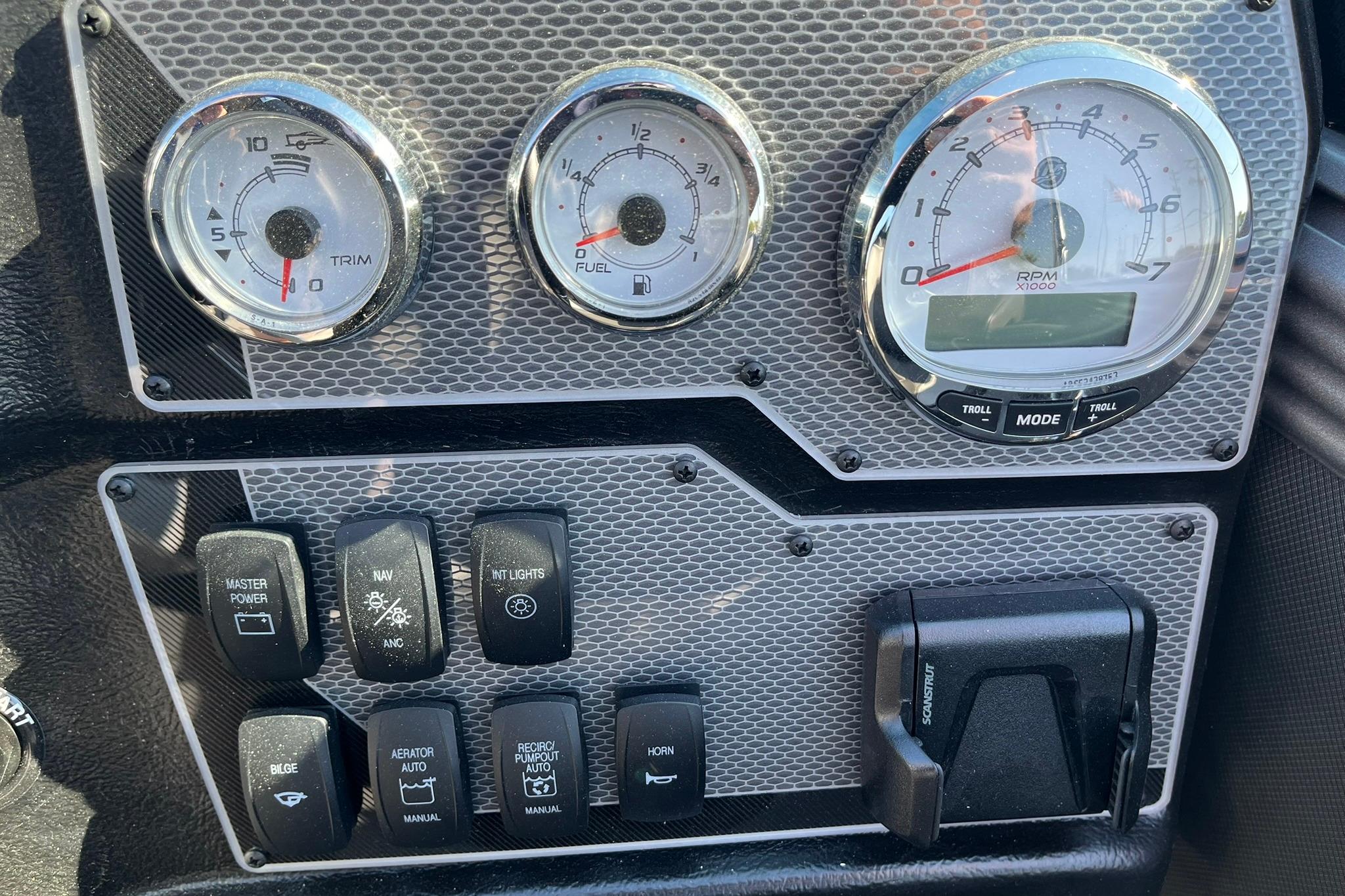 Dashboard of 2026 Lund 2275 Baron boat with gauges and control switches.