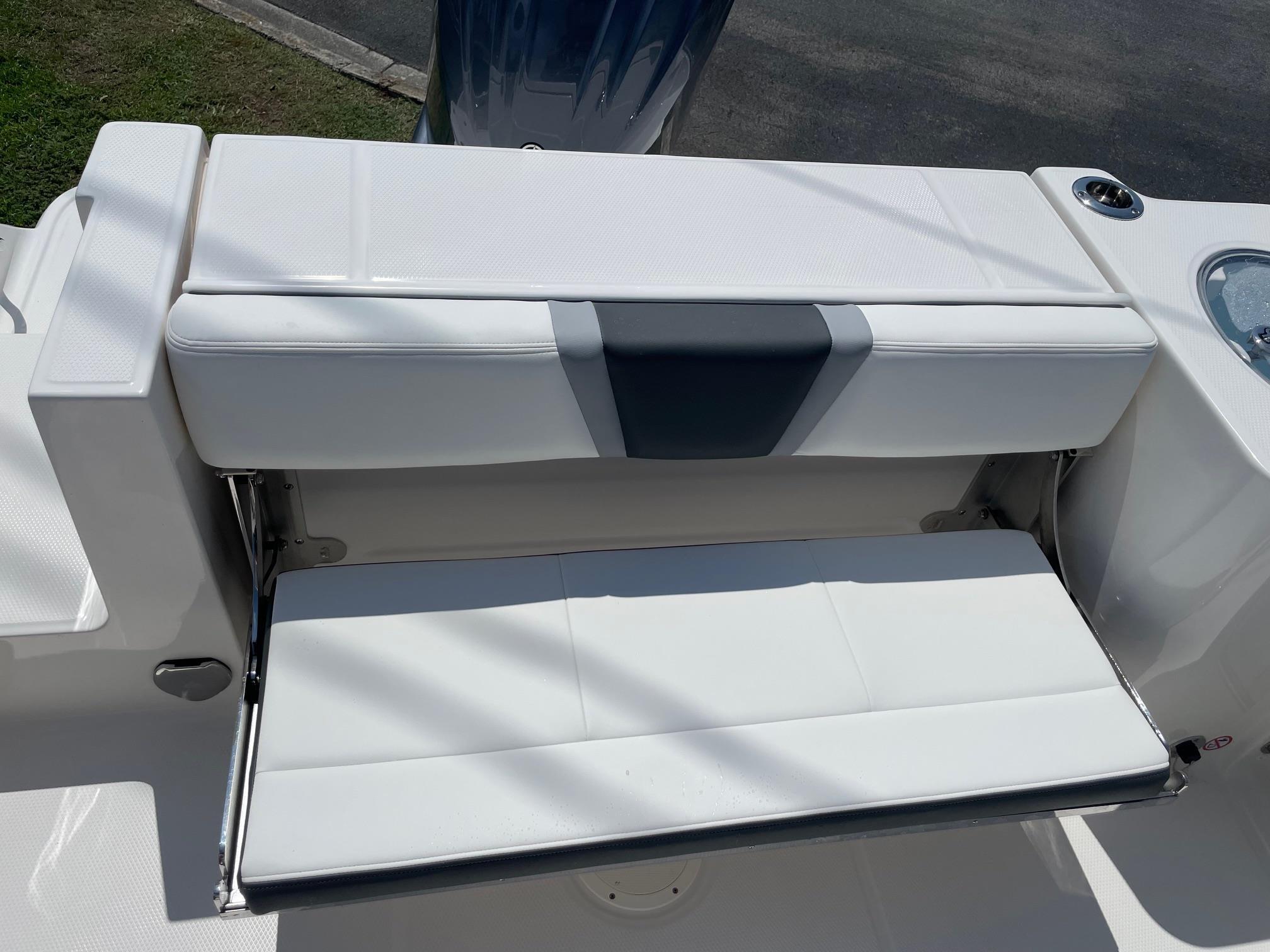 2025 Robalo R230 Center Console boat with white cushioned seating.