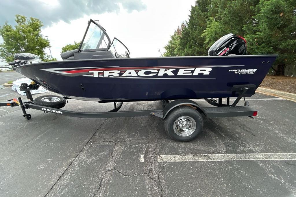 2025 Tracker Pro Guide V-175 WT boat on trailer in parking lot.
