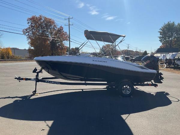 2025 Tahoe T18 boat on trailer, parked outdoors under clear sky.