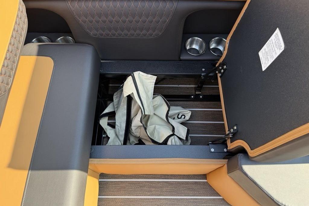 Open storage compartment in 2026 Premier 250 Solaris RS CL boat interior.
