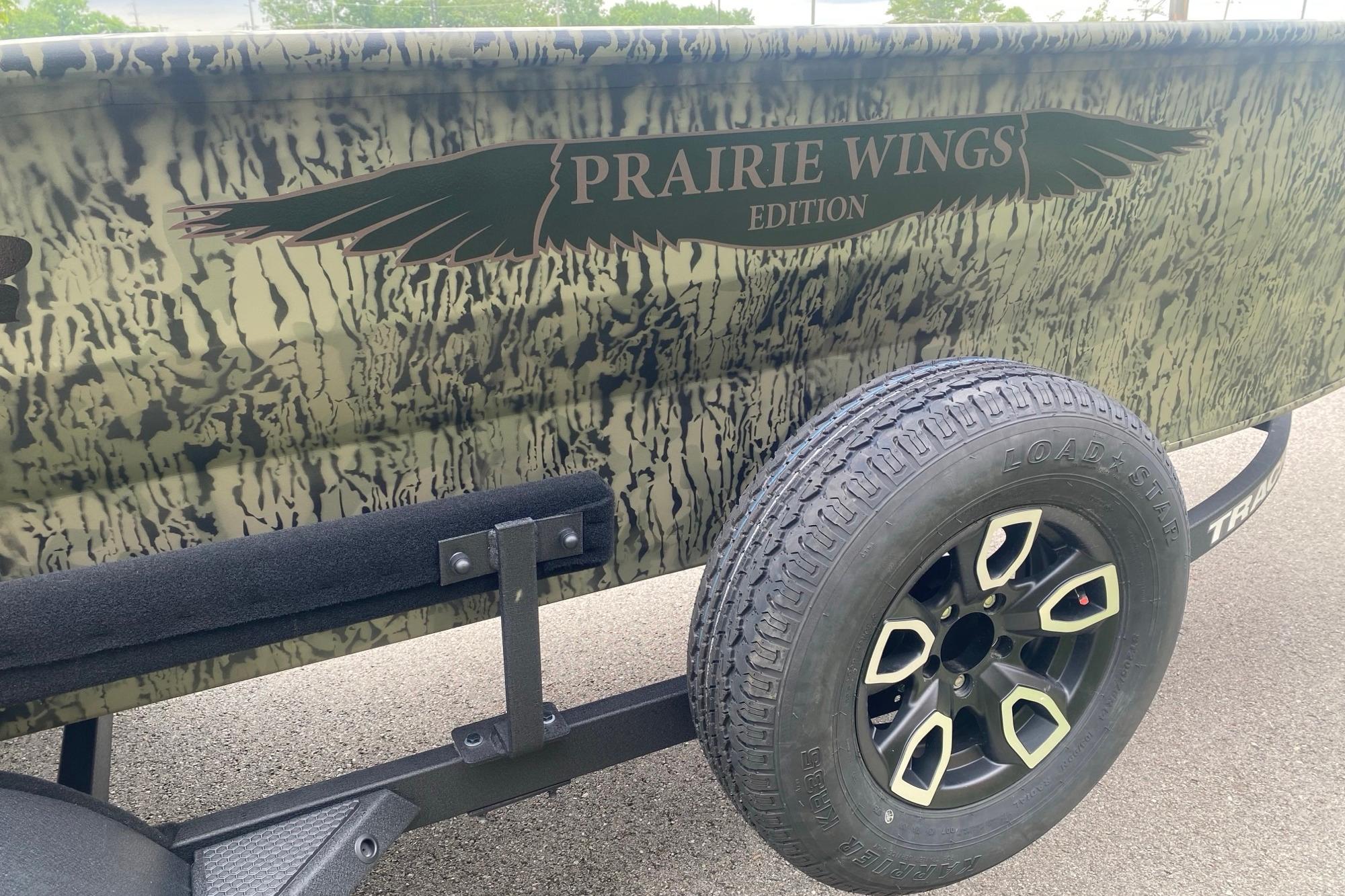 2026 Tracker Grizzly 1650 T Prairie Wings Edition with camouflage design and trailer tire.
