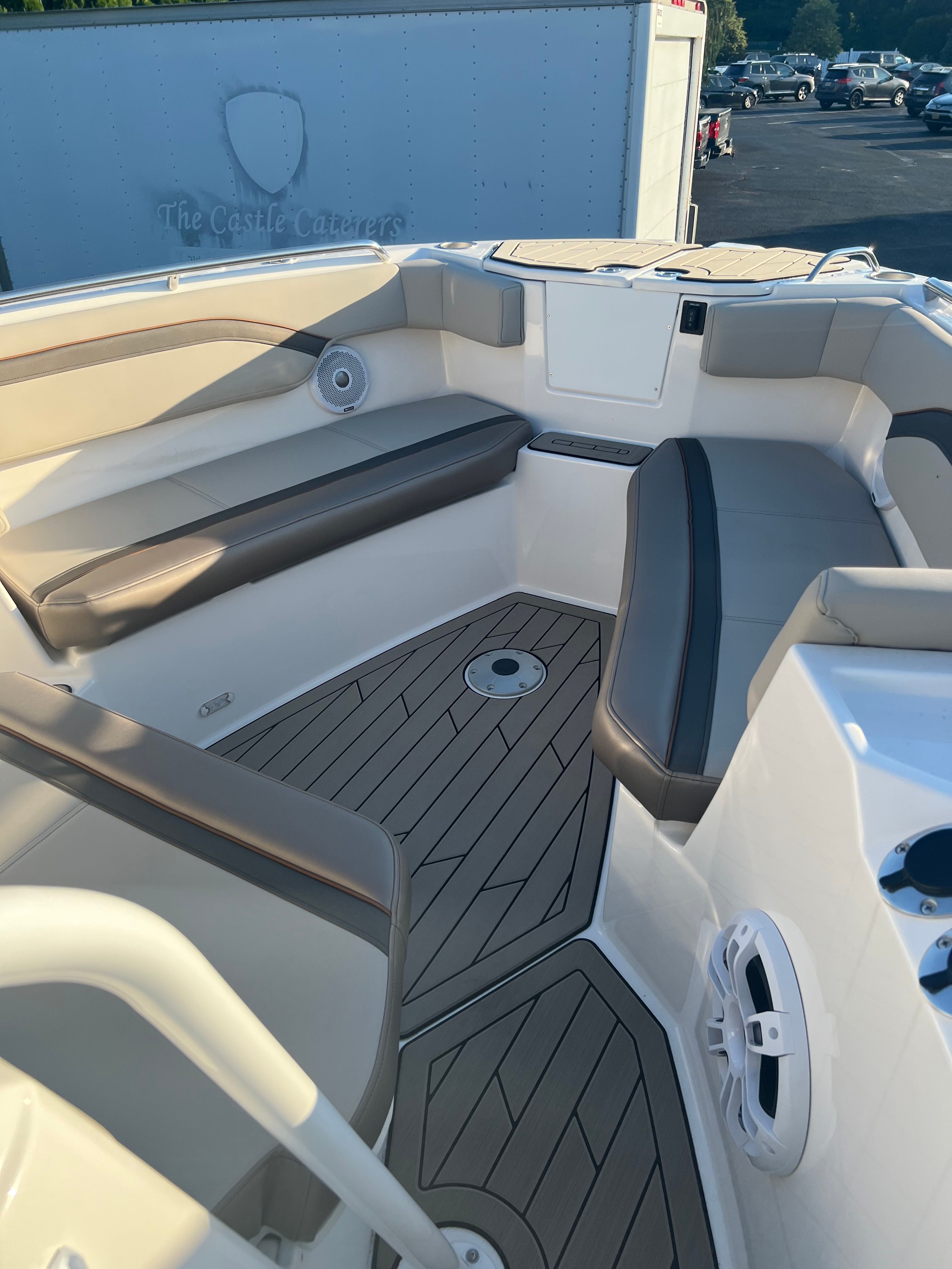 The image shows the cockpit of a 2022 Cutwater C-24 CW boat with sleek seating.