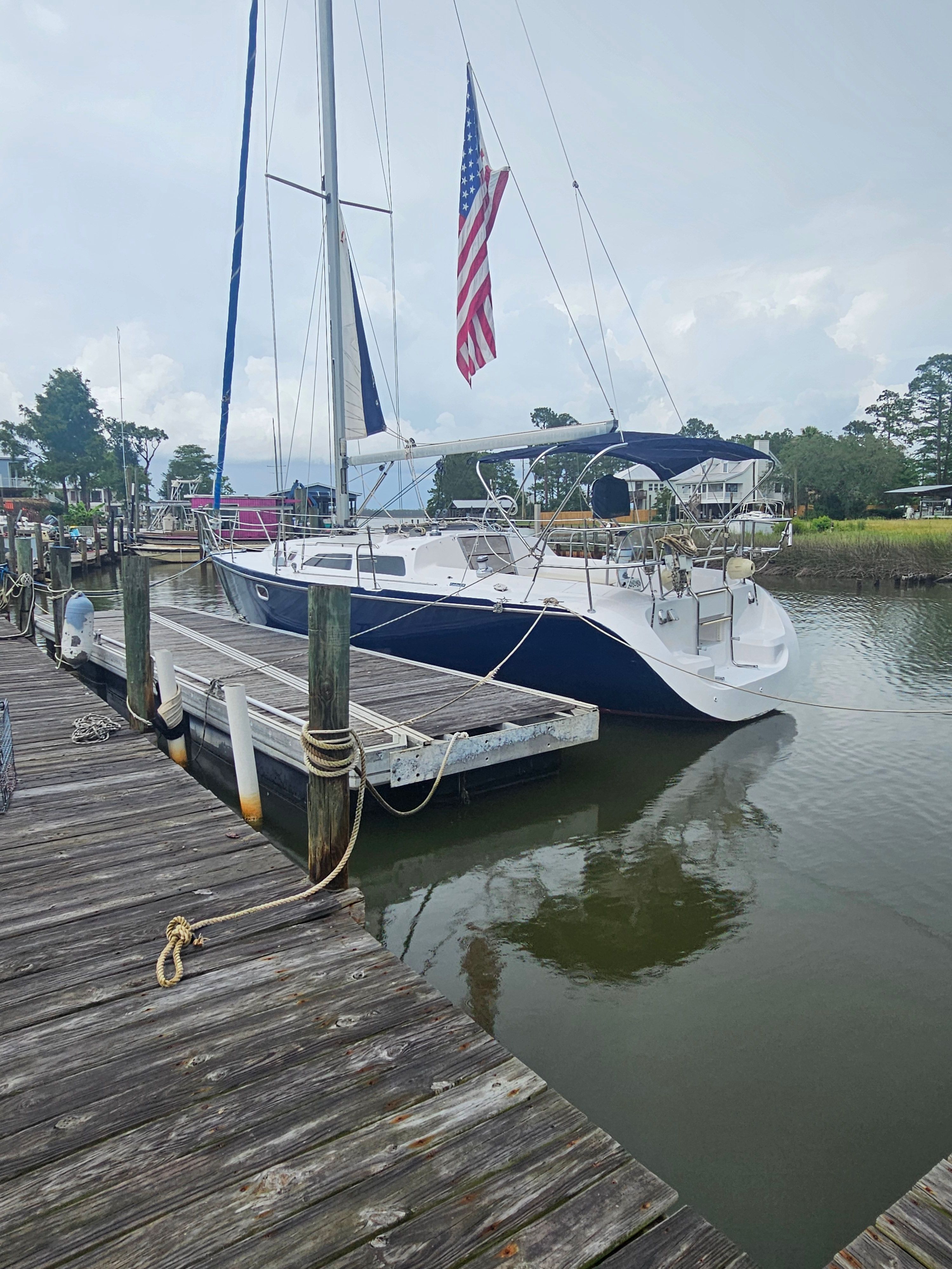 2006 Catalina 320 sailboat docked with American flag.