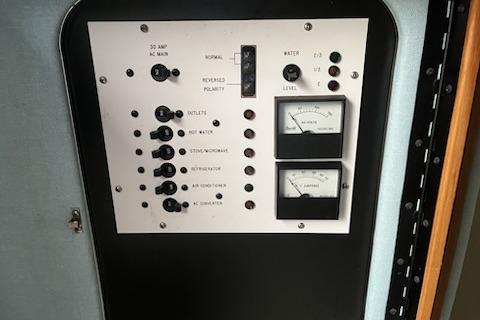 Control panel of a 1989 Sea Ray 300 Sundancer boat with gauges and switches.