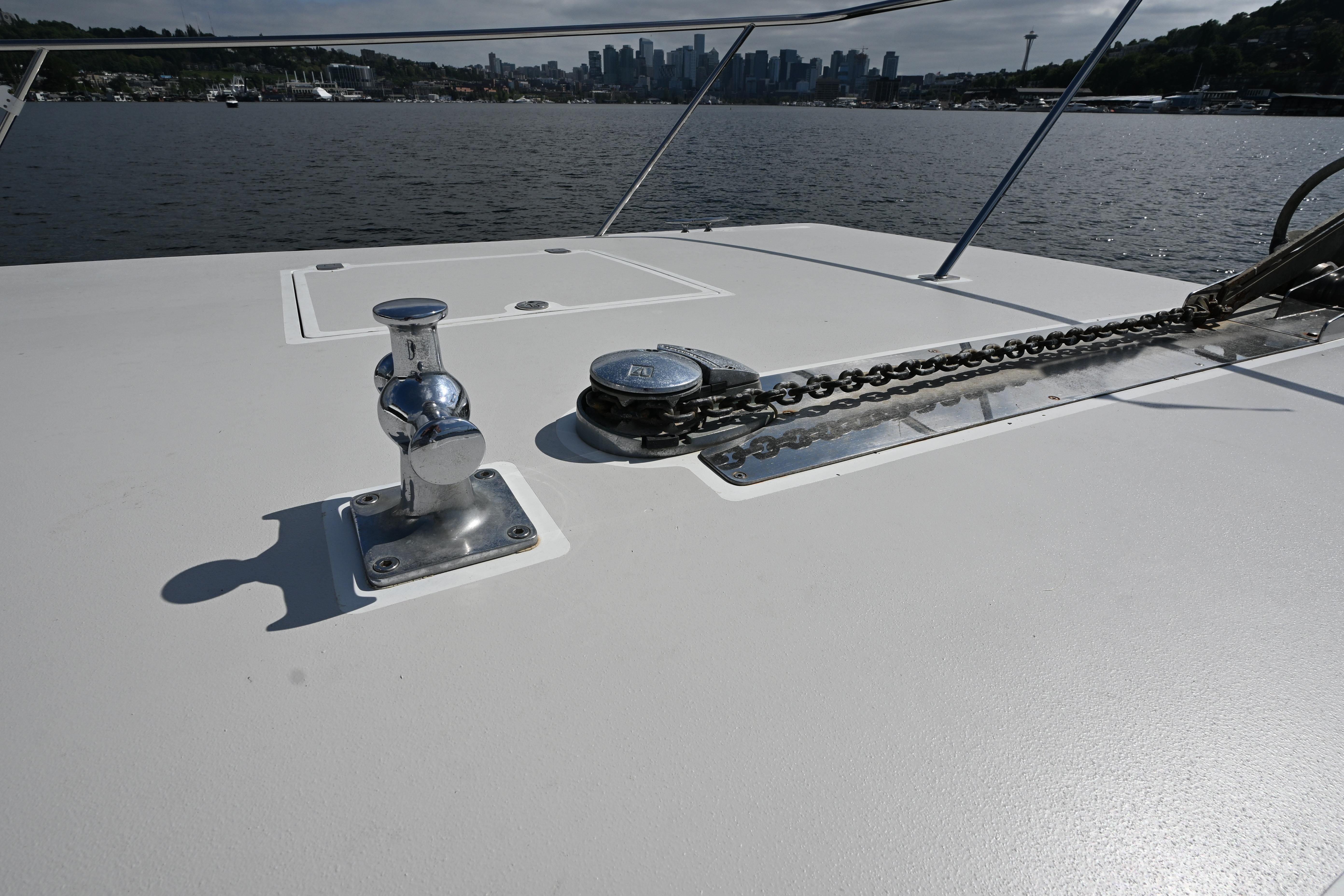 Deck of 2002 Roger Hill Power Cat 41.4 with anchor chain and skyline view.