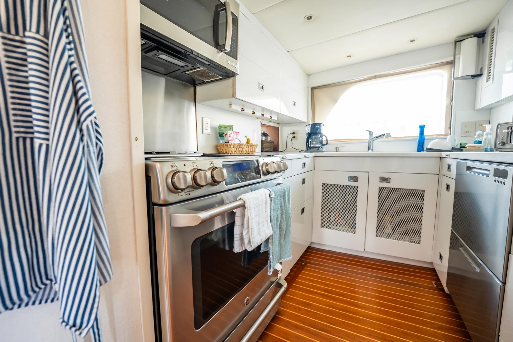 Modern kitchen interior on 1972 Trumpy 72 Motor Yacht with stainless steel appliances.