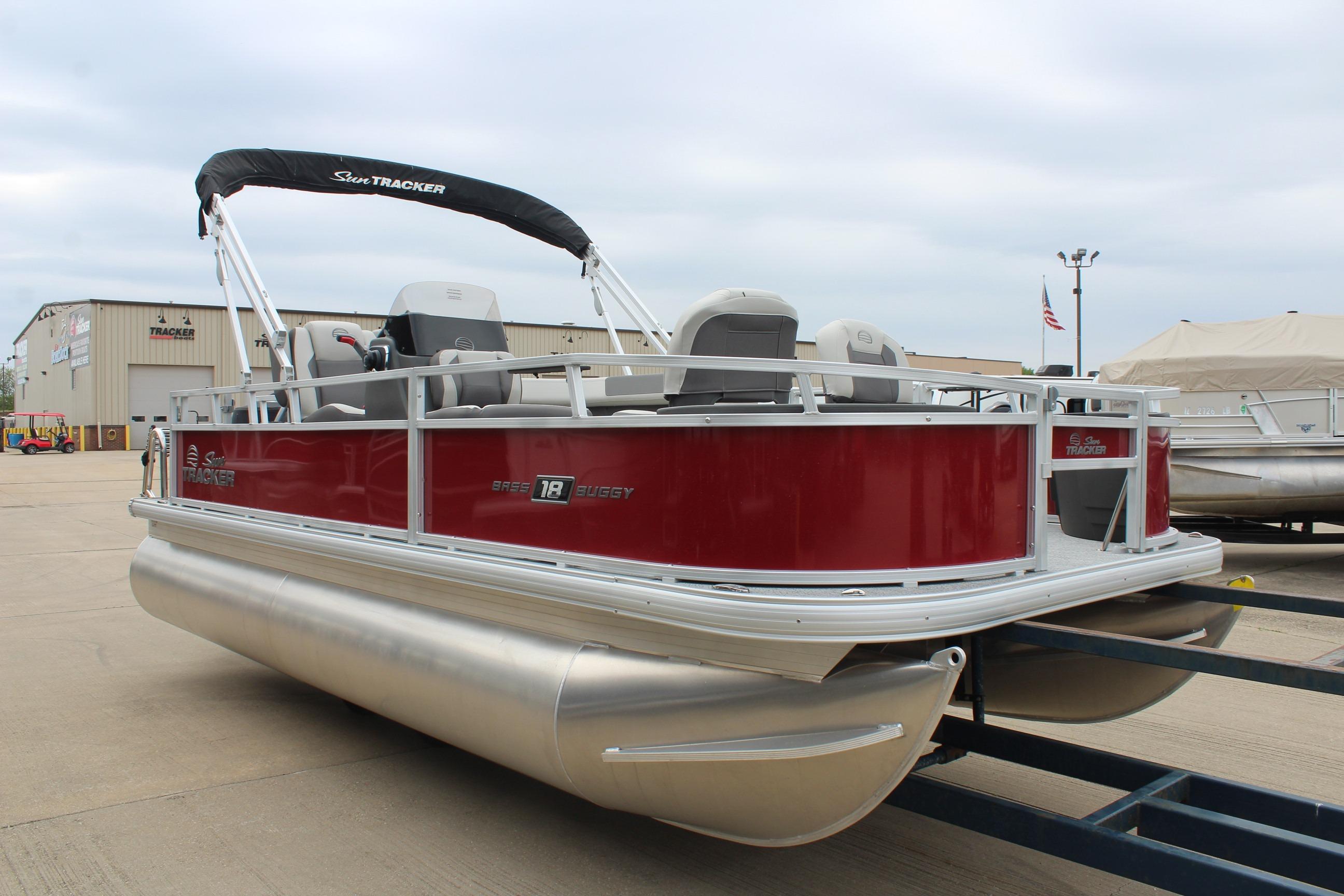 2026 Sun Tracker Bass Buggy 18 DLX pontoon boat in a showroom setting.