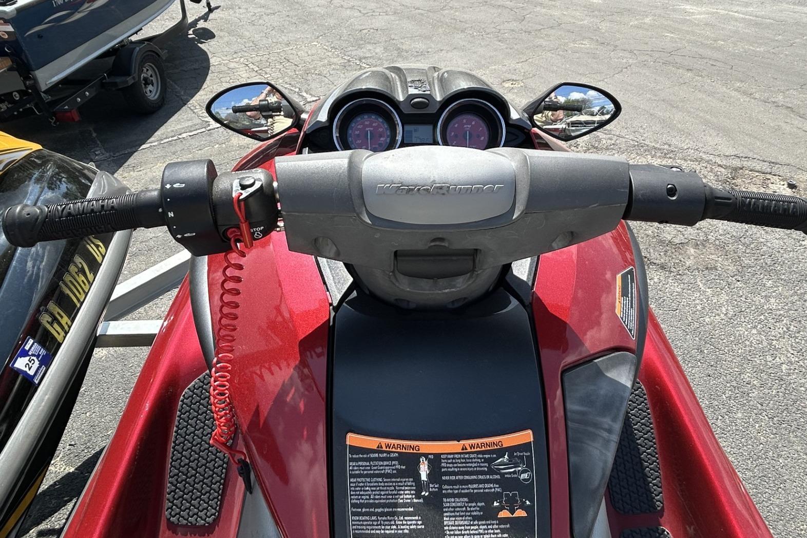 2011 Yamaha WaveRunner FZS dashboard and handlebars, featuring mirrors and warning labels.