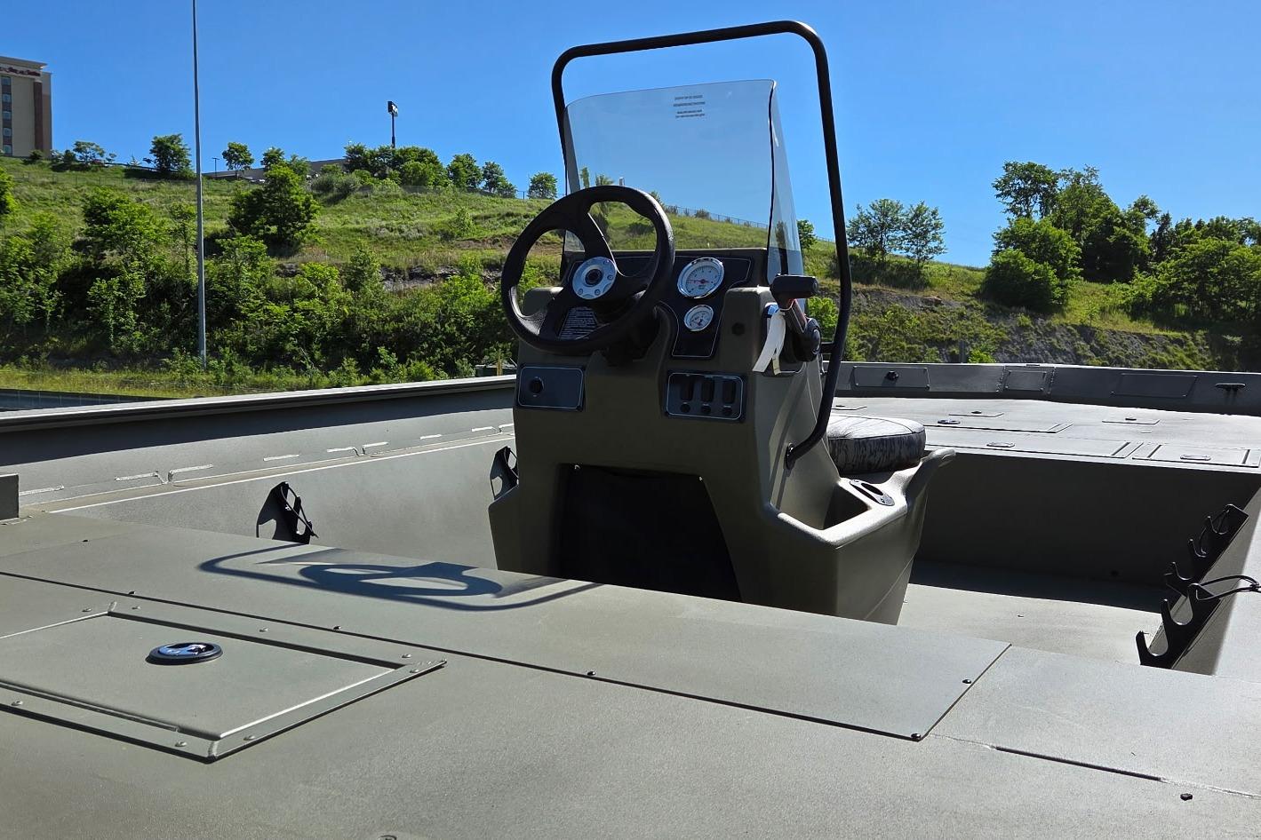 2026 Tracker Grizzly 2072 CC boat interior with steering console, gauges, and seating.