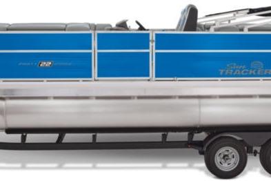 2026 Sun Tracker Party Barge 22 DLX pontoon boat with blue paneling and trailer.