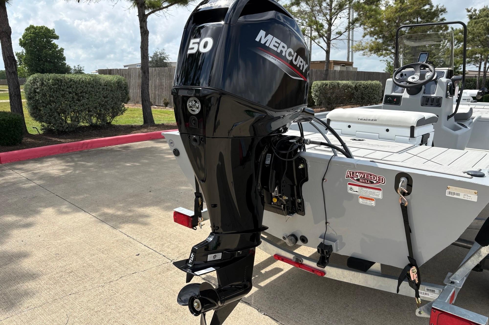 2026 Tracker Bass Tracker Classic CC with Mercury 50 outboard motor in a parking area.