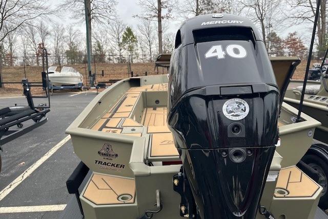 2026 Tracker Grizzly 1756 T Marsh boat with Mercury 40 engine in parking lot.