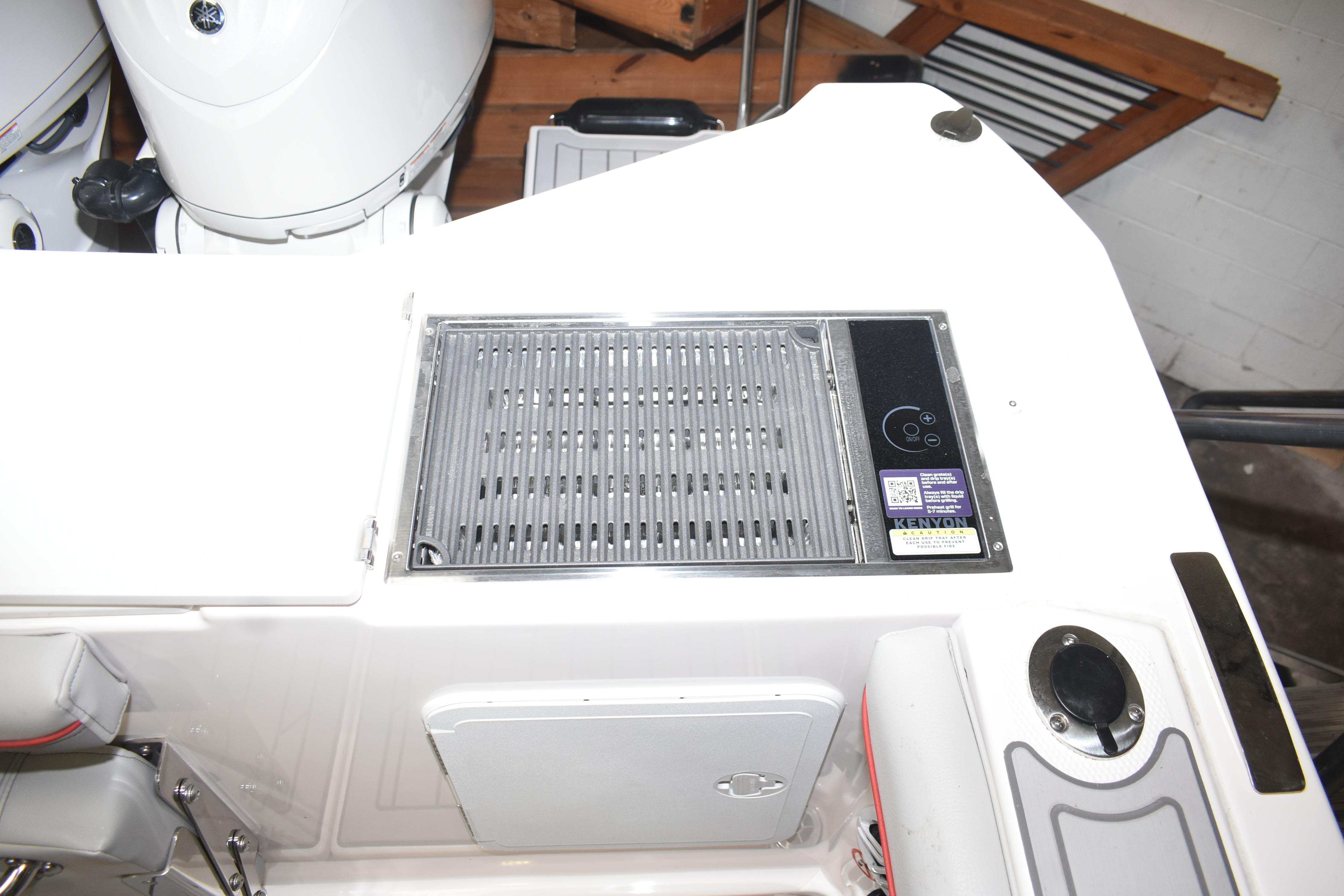 2025 Solara S-310 CW boat with integrated Kenyon grill and storage compartment.