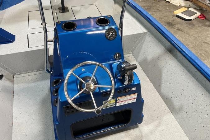 2025 SeaArk Shadow 187T boat console with blue steering wheel and controls.