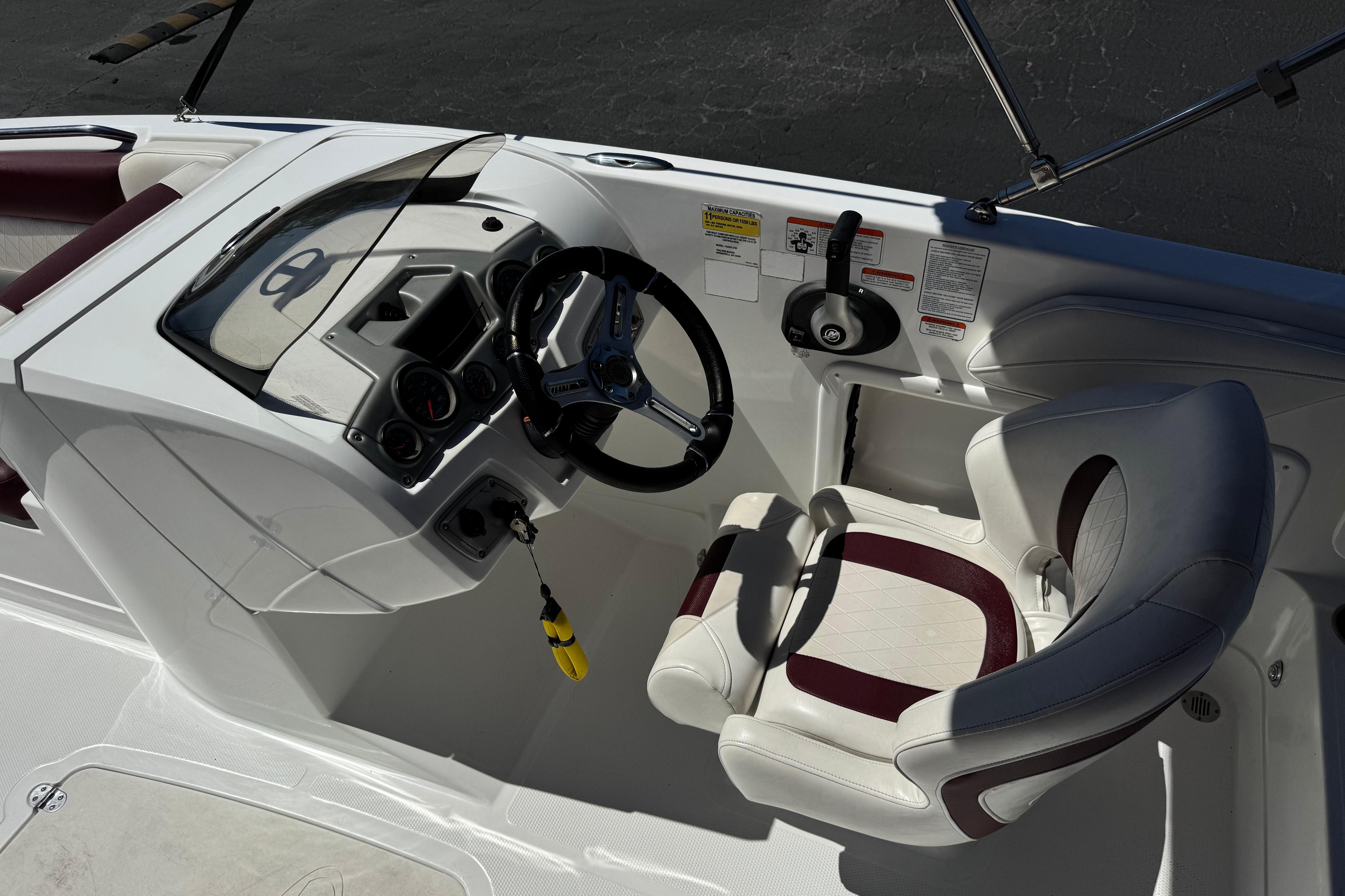 Cockpit of 2017 Tahoe 2150 boat with steering wheel and comfortable seating.