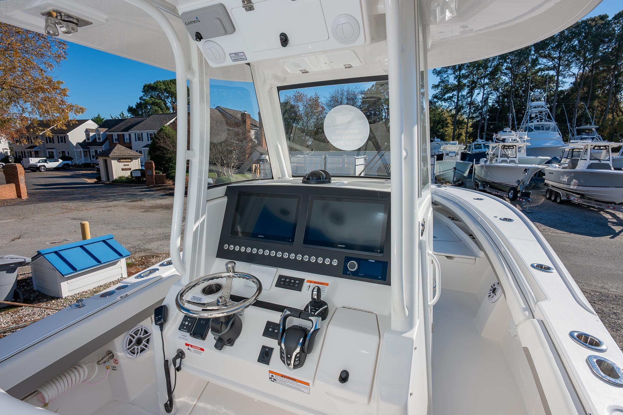 2026 Regulator 28 boat cockpit with advanced navigation system and steering wheel.