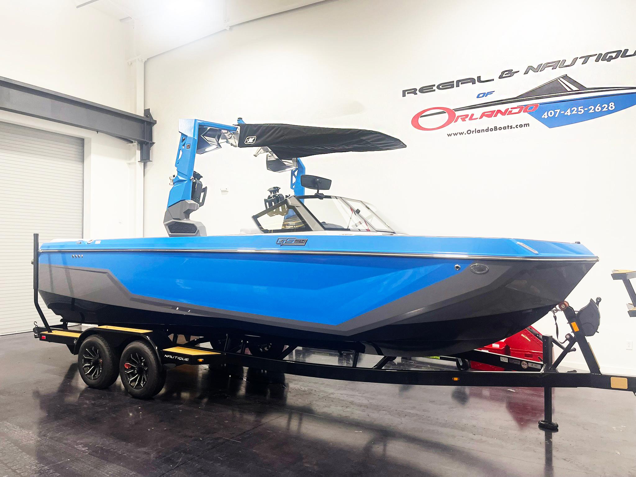 2025 Nautique Super Air Nautique GS24 boat in showroom, blue and gray design on trailer.