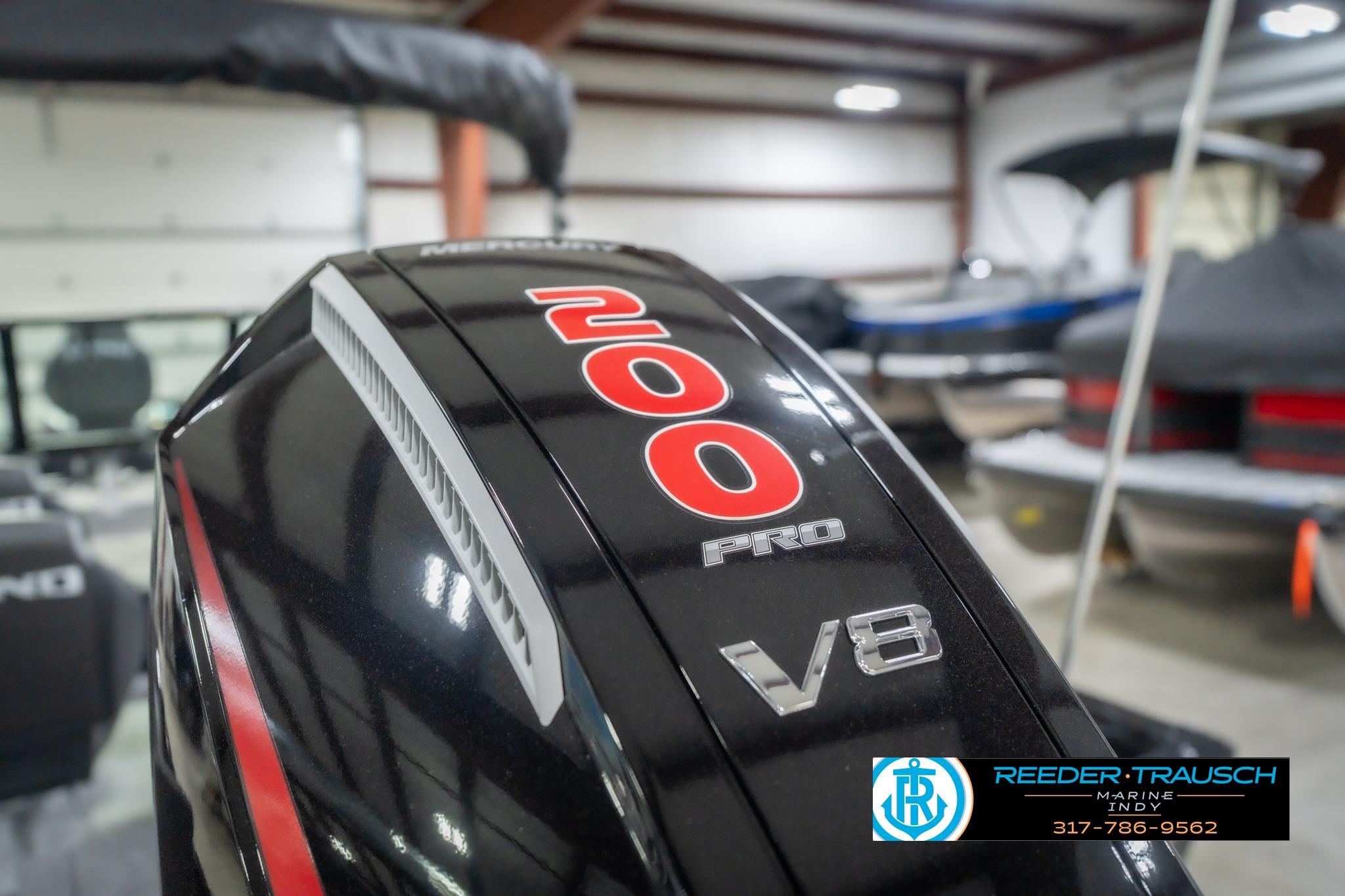 Close-up of a 2026 Lund 2075 Impact XS boat's 200 Pro V8 engine in a showroom.