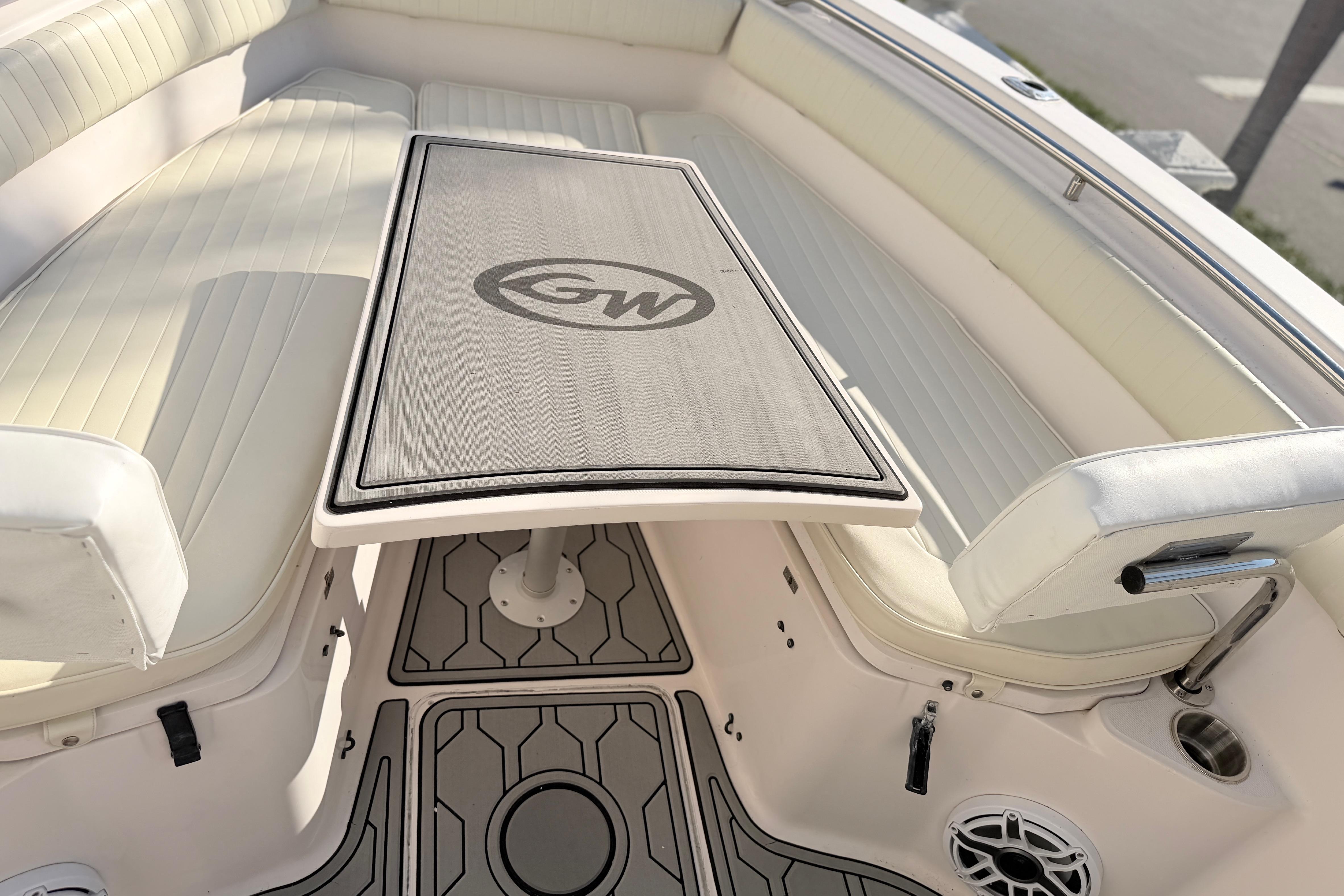 2004 Grady White 273 boat interior with cushioned seating and table.