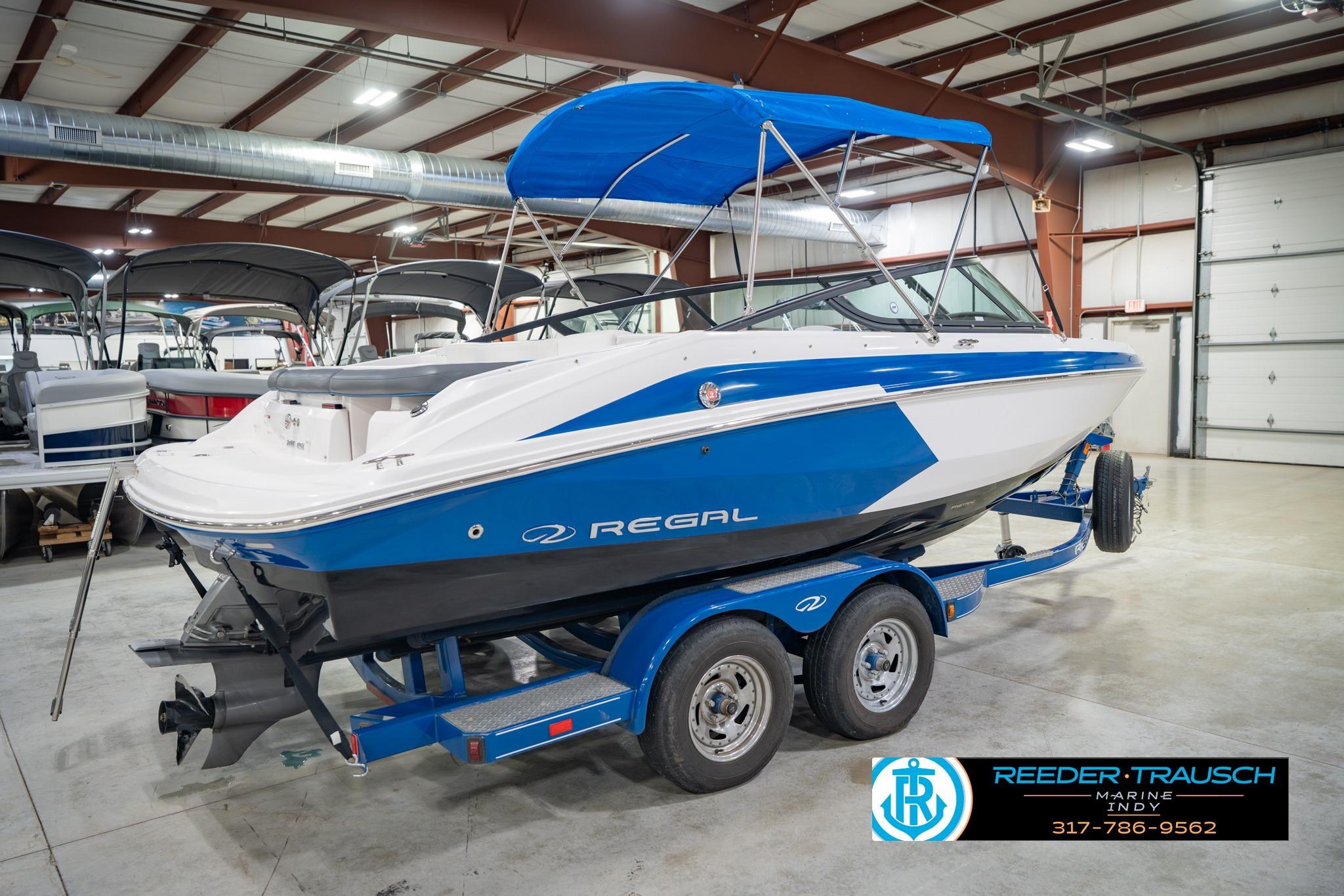 2015 Regal 2000 ESX Bowrider boat with blue and white design in indoor showroom.