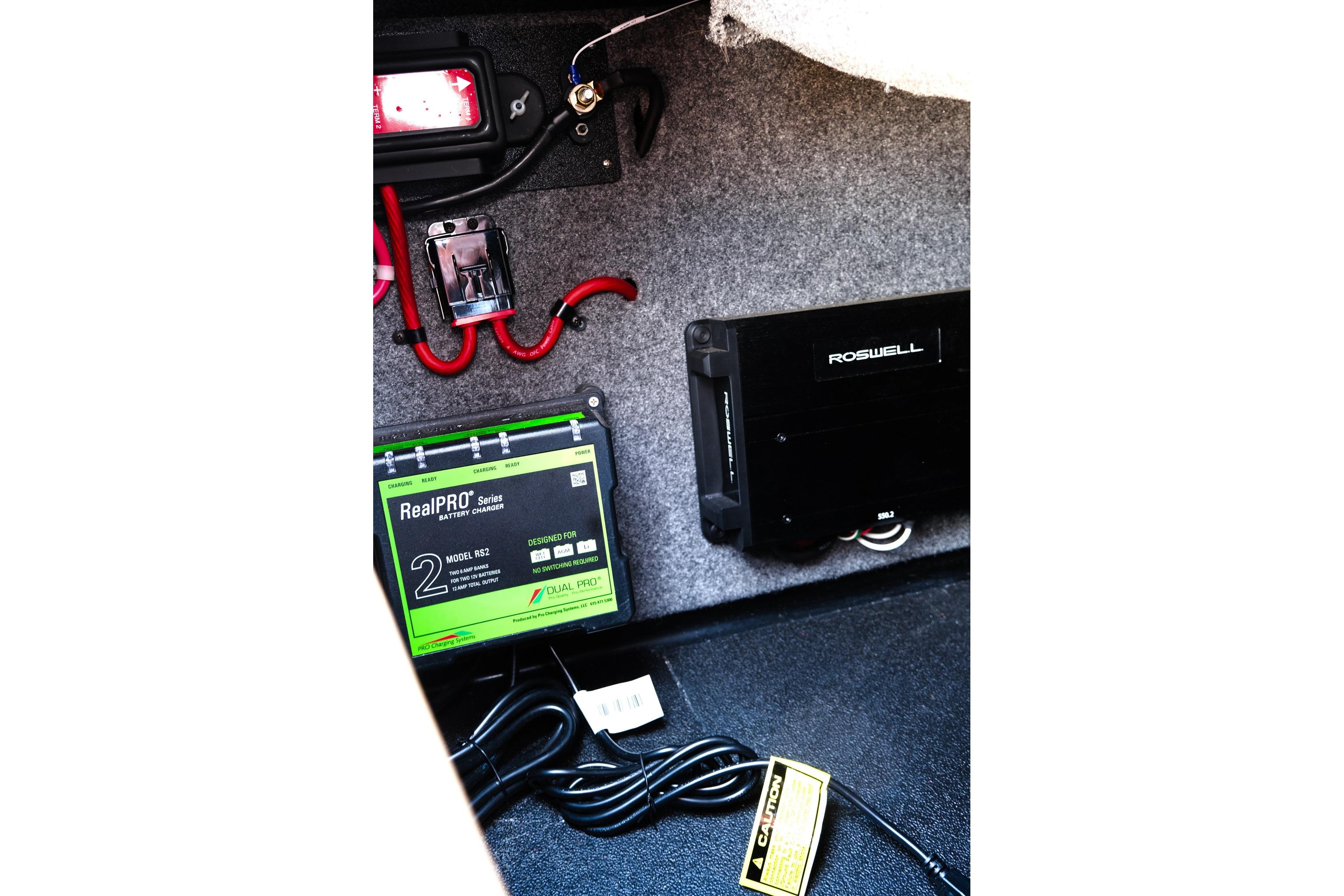 2023 Moomba Mondo boat interior showing battery charger and wiring setup.
