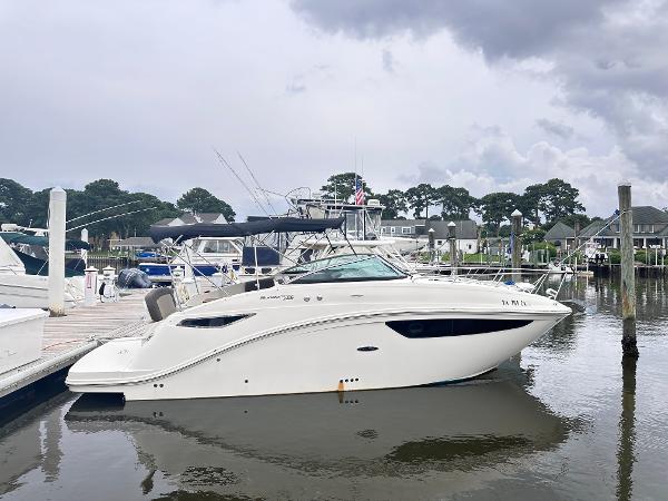 2015 Sea Ray 260 Sundancer docked at a marina under cloudy skies.