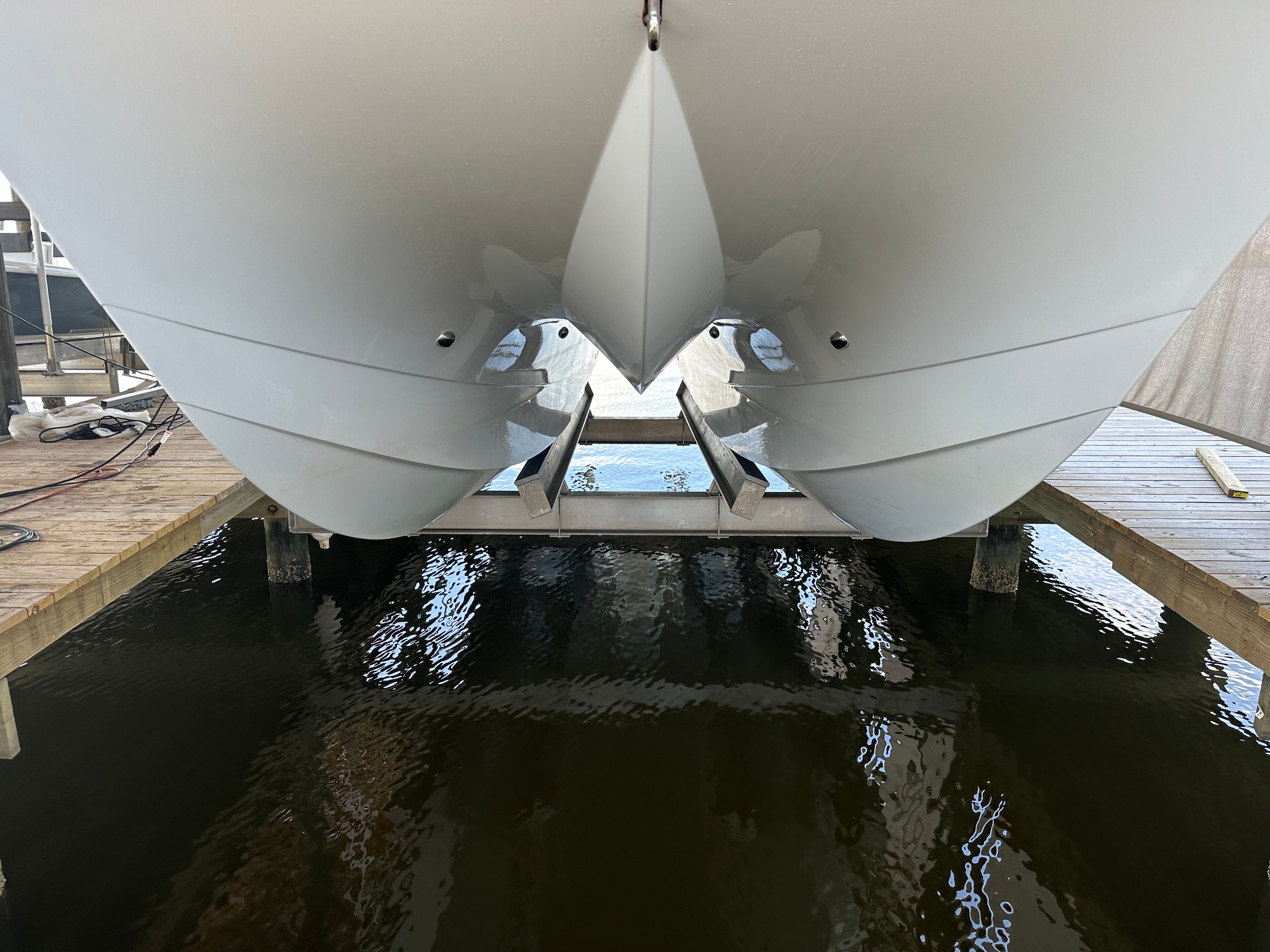 A boat is docked, partially above water, showing a clear view of the hull.