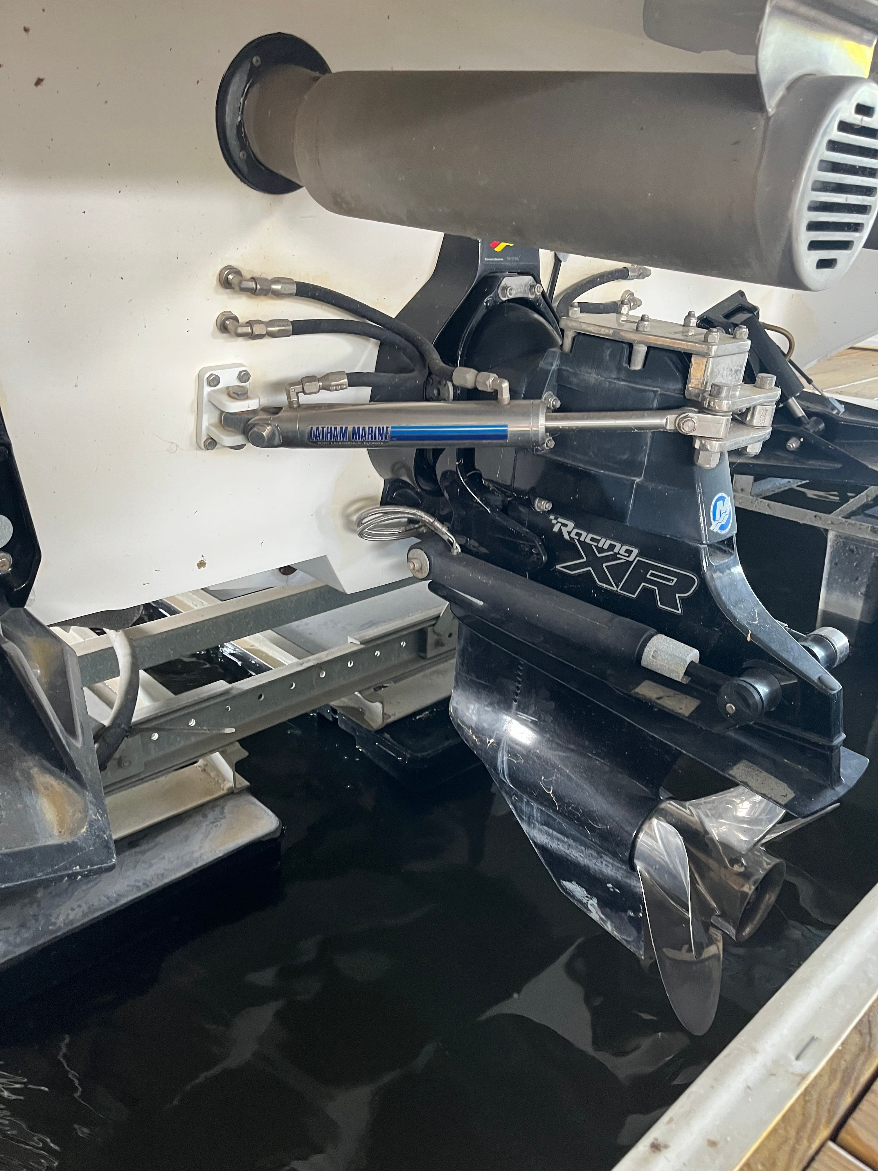 Close-up of a boat engine with propeller in the water.