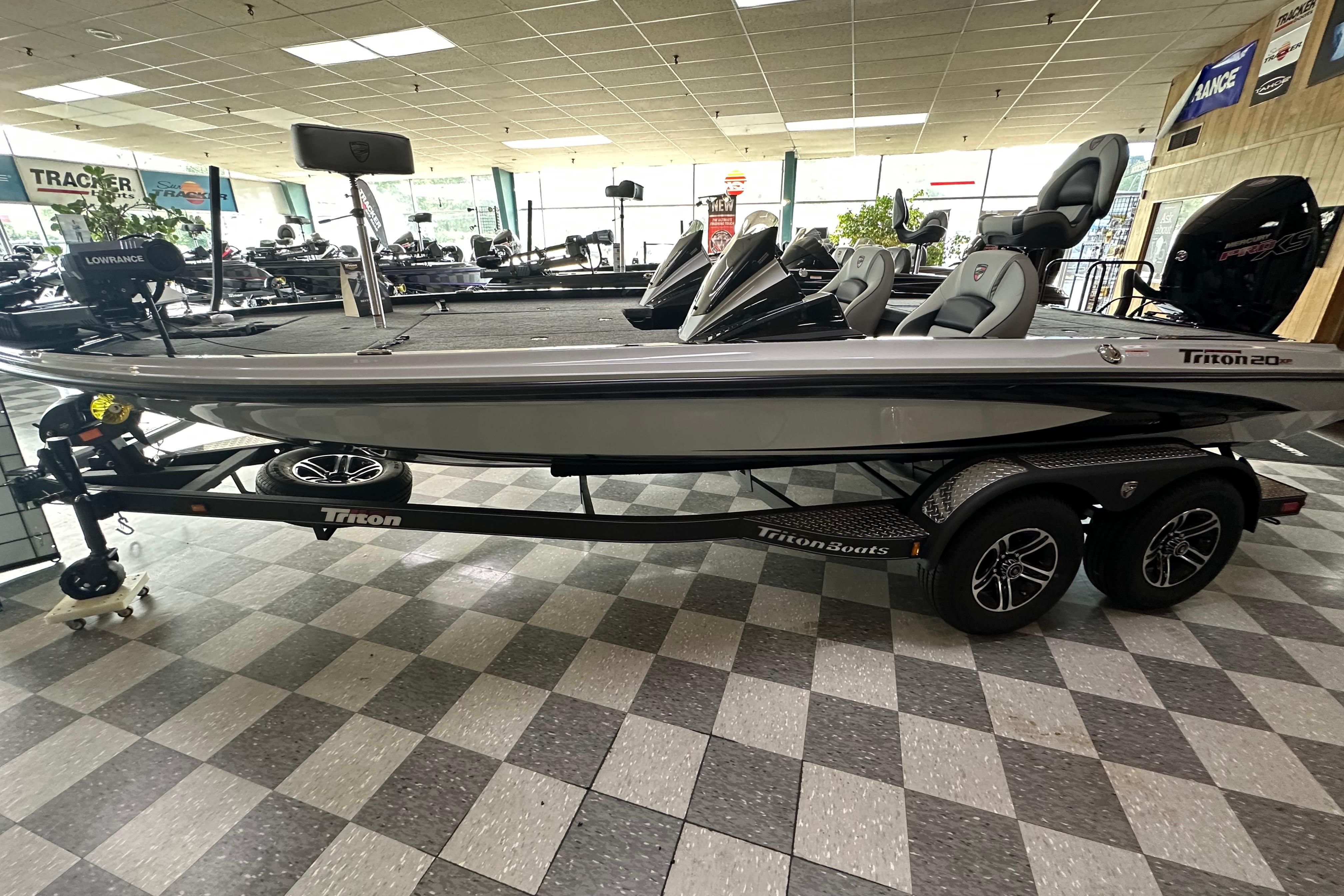 2024 Triton 20XP Patriot boat displayed in showroom, featuring sleek design and modern equipment.