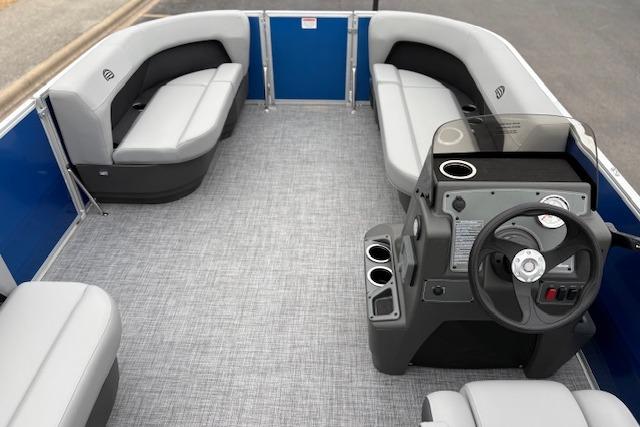 2026 Sun Tracker Party Barge 16 DLX interior with seating and steering console.