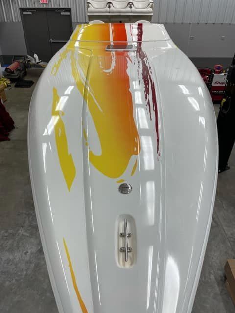 2003 Sunsation 32 Dominator with colorful design in a warehouse.