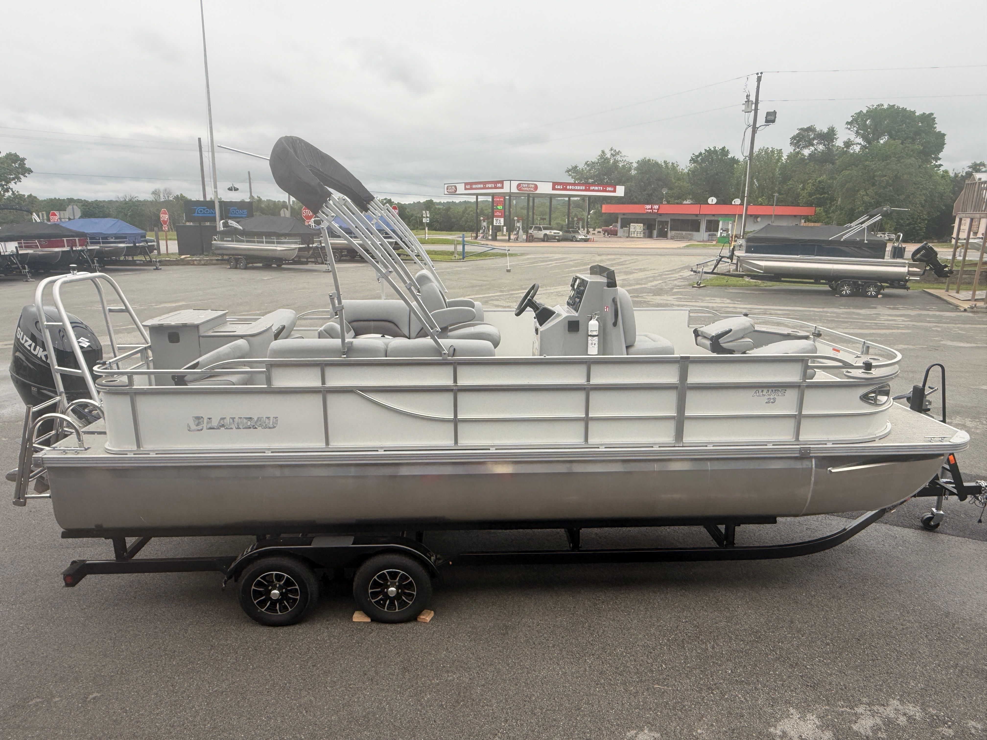 2026 Landau Alure 23CC Fish boat on trailer outdoors.