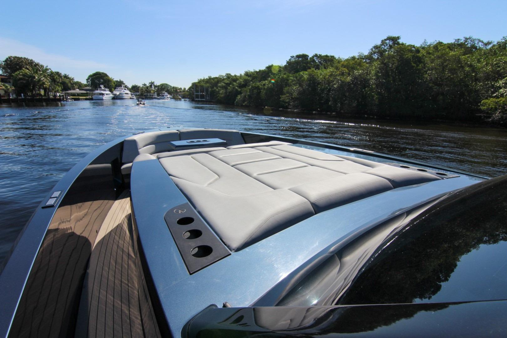 2022 Vanquish Yachts VQ45 cruising on a scenic waterway with lush greenery.